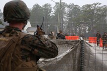 Service members with Ragnarok Company, 2nd Supply Battalion, 2nd Marine Logistics Group return from a patrol during a basic skills course at the Battle Skills Training School aboard Camp Lejeune, N.C., Dec. 4, 2013. The course prepared Marines and sailors for small-unit environments such as the upcoming winter warfare training operation in Bridgeport, Calif., and the NATO Cold Response 2014 exercise in Norway.