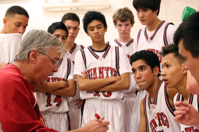 Eddie Cottrell, Warriors head coach, instructs his team during a time-out while playing a basketball game at the Quantico Middle/High School on Dec. 2, 2103. The Warriors won their first game of the season 65-39. 