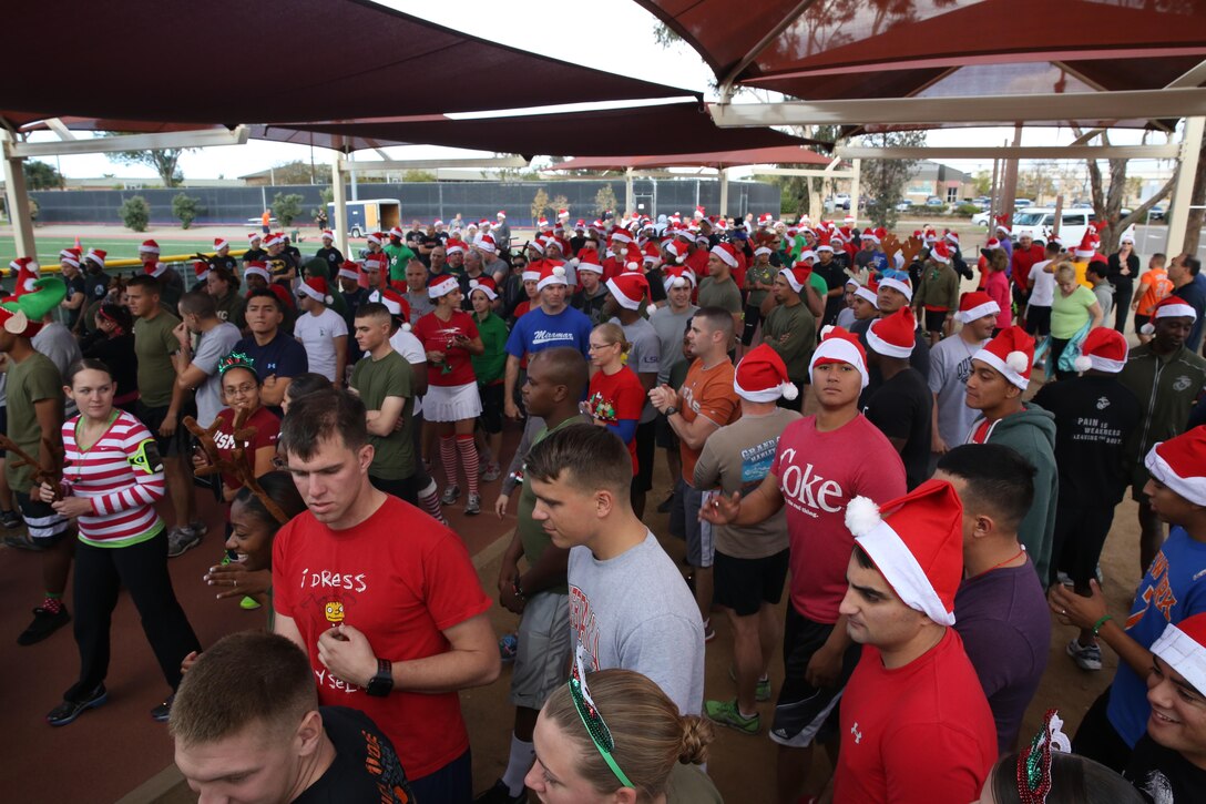 Marines, Sailors and civilians gather for the Jingle Bell Jog at the Miramar Sports Complex aboard Marine Corps Air Station Miramar, Calif., Dec. 5. Participants wore festive hats and other accessories for the run on the installation. 