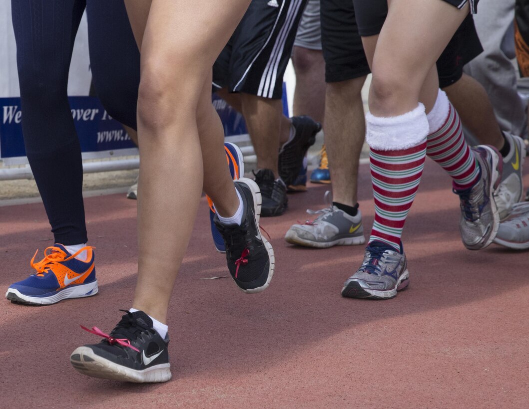 Marines, Sailors and civilians run in the Jingle Bell Jog aboard Marine Corps Air Station Miramar, Calif., Dec. 5. Participants wore bells on their shoes while running the course.