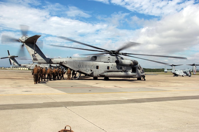 Marines and corpsmen embark a CH-53E Super Stallion helicopter Nov. 7 at Marine Corps Air Station Futenma during a training event. The Marines and sailors trained on how to properly board and disembark a helicopter as well as securing a stretcher with a casualty in a helicopter. The Marines and corpsmen are with 3rd Medical Battalion, 3rd Marine Logistics Group, III Marine Expeditionary Force. The CH-53E and crew are with Marine Heavy Helicopter Squadron 772, currently assigned to Marine Aircraft Group 36, 1st Marine Aircraft Wing, III MEF, under the unit deployment program. (U.S. Marine Corps photo by Lance Cpl. Donald T. Peterson/Released)