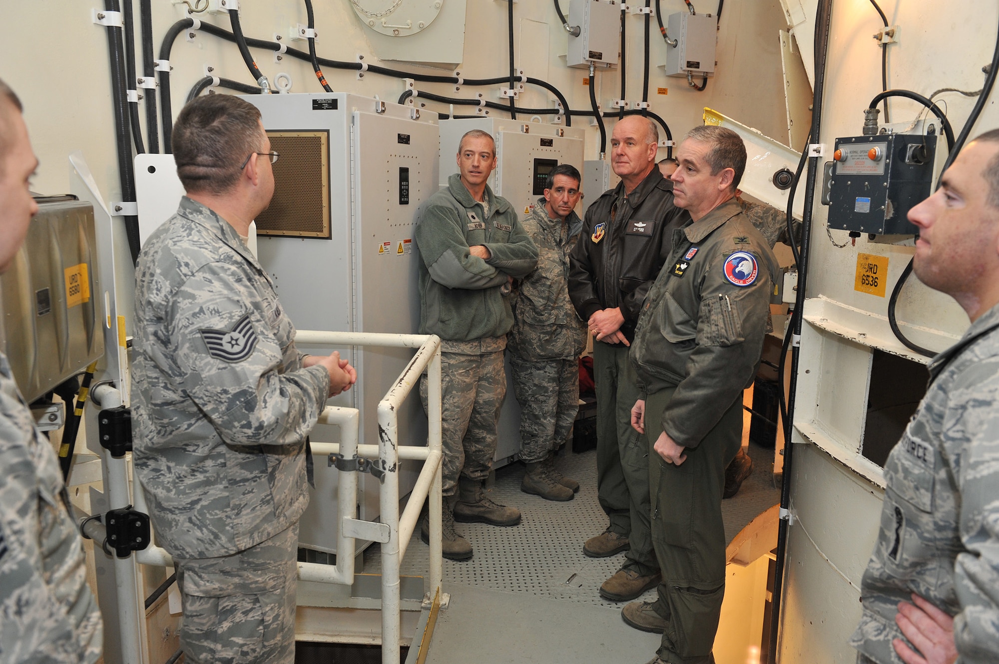 Tech. Sgt. William Kaelber, 341st Maintenance Operations Squadron maintenance trainer NCO in charge (left), explains the mission of the T-9 maintenance trainer to commanders from the Montana Air National Guard on Nov. 26.  Listening, in the center from left to right, are Lt. Col. Patrick Hover, 120th Maintenance Group commander; Col. Thomas Mora, 120th Mission Support Group commander; Col. J. Peter Hronek, 120th Fighter Wing commander; and Col. Shane Sanders, 120th Operations Group commander.  (U.S. Air Force photo/John Turner)