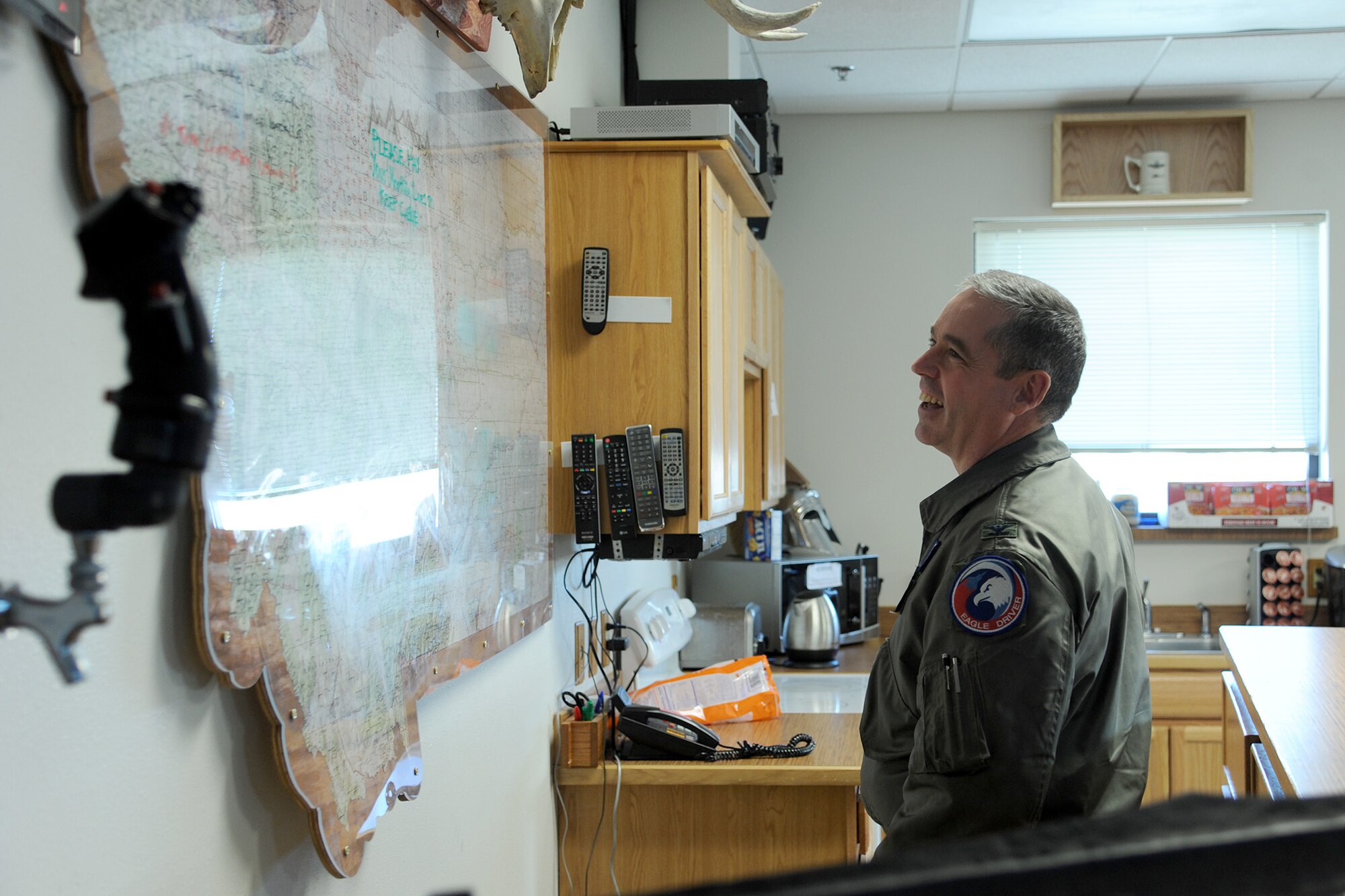 Col. Shane Sanders, Montana Air National Guard 120th Operations Group commander, looks at a map of Montana during a tour of the 40th Helicopter Squadron on Nov. 26.  Sanders, along with three other members of MTANG leadership, visited Malmstrom Air Force Base for a day-long tour.  (U.S. Air Force photo/Senior Airman Cortney Paxton)