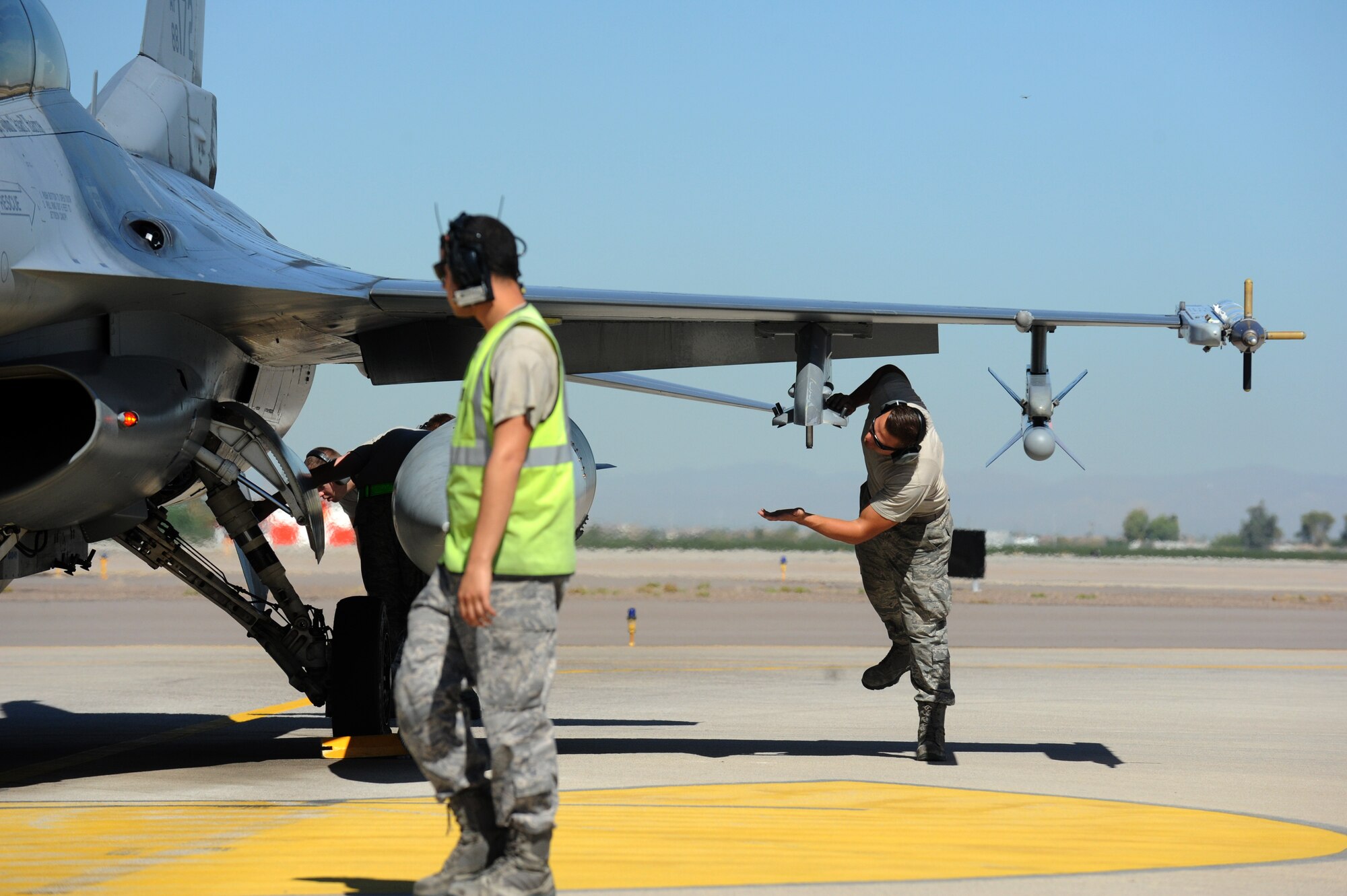 End-of-runway Airmen perform a post-flight inspection on an F-16 Fighting Falcon. EOR members check each aircraft for leaks, loose parts and damage to tires or the aircraft. (U.S. Air Force photo/Staff Sgt. Nestor Cruz)