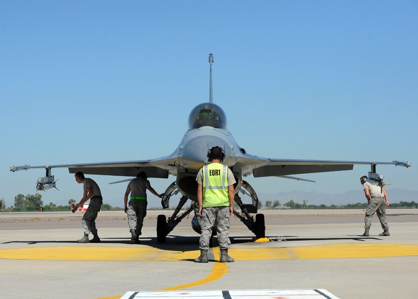 End-of-runway Airmen perform a preflight inspection on an F-16 Fighting Falcon. Part of the inspection is removing the safety pins from the jet’s munitions prior to take off. (U.S. Air Force photo/Staff Sgt. Nestor Cruz)