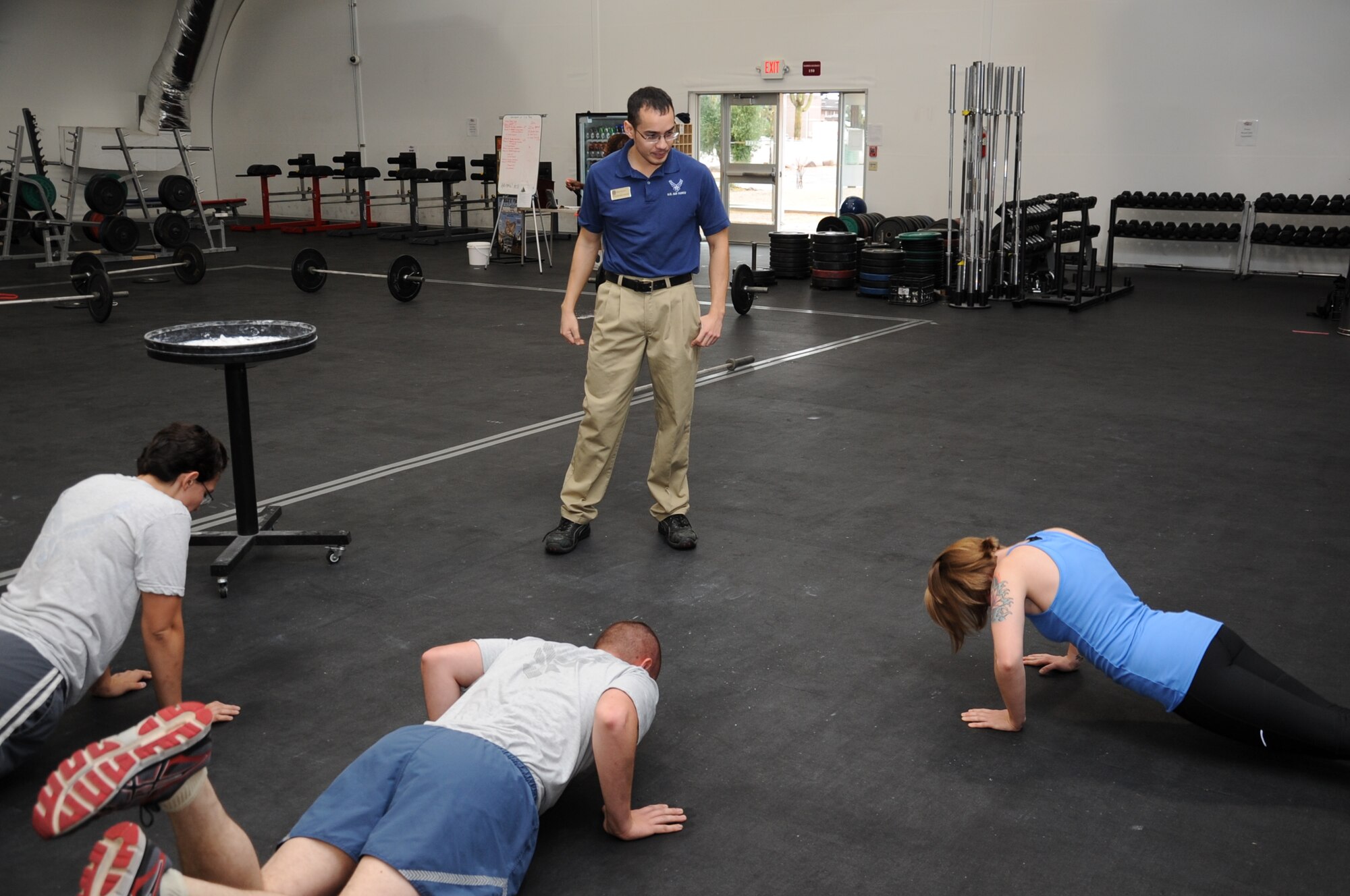 Matthew Corcoran, 56th Force Support Squadron fitness specialist instructor, coaches participants during the last five minutes of their warrior fitness routine Nov. 22 at the Warrior Fitness Center. Warrior fitness includes gymnastics, weightlifting and endurance, with variations of those exercises. (U.S. Air Force photo/Staff Sgt. Luther Mitchell Jr.)