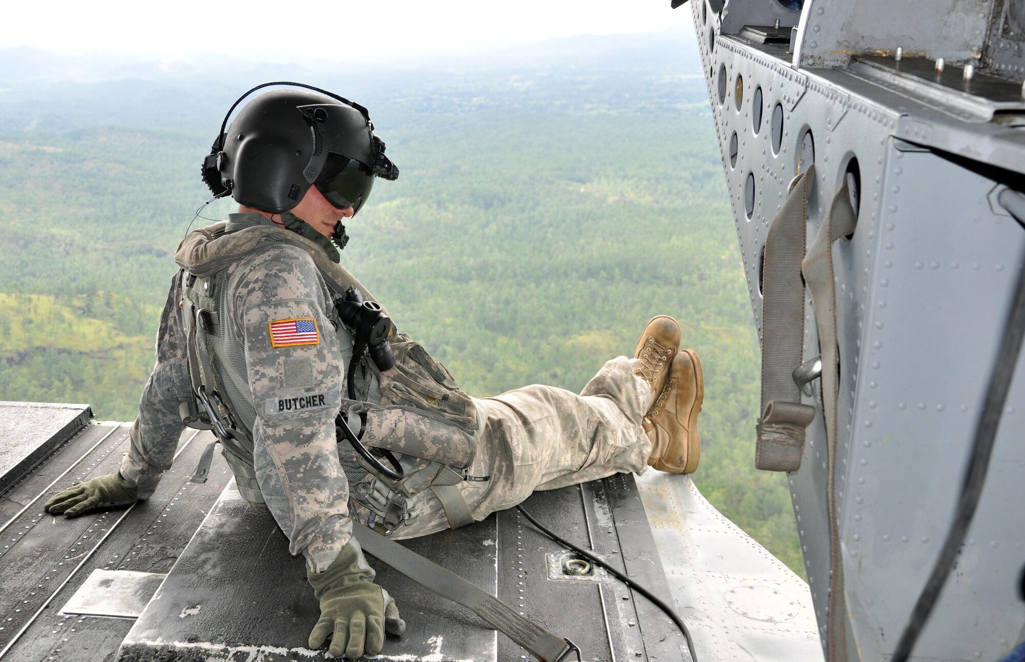 U.S. Army Staff Sgt. David Butcher, a flight engineer assigned to Joint Task Force-Bravo's 1-228th Aviation Regiment, takes in the view from the ramp of a CH-47 Chinook helicopter as it cruises over the Honduran landscape, Dec. 2, 2013. The Chinook was transporting personnel and equipment to Mocoron in the Department of Gracias a Dios, Honduras, as part of a Culminating Exercise (CULEX) conducted by Joint Task Force-Bravo, Dec. 2-5, 2013. During the CULEX, Joint Task Force-Bravo conducted numerous exercise and real world operations. These included the deployment of the U.S. Southern Command Survey and Assessment Team as part of a natural disaster exercise scenario, as well as conducting two real-world Medical Readiness Training Exercises (MEDRETES) to provide medical care to citizens of remote Honduran villages. (U.S. Air Force photo by Capt. Zach Anderson)