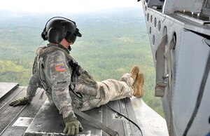 U.S. Army Staff Sgt. David Butcher, a flight engineer assigned to Joint Task Force-Bravo's 1-228th Aviation Regiment, takes in the view from the ramp of a CH-47 Chinook helicopter as it cruises over the Honduran landscape, Dec. 2, 2013. The Chinook was transporting personnel and equipment to Mocoron in the Department of Gracias a Dios, Honduras, as part of a Culminating Exercise (CULEX) conducted by Joint Task Force-Bravo, Dec. 2-5, 2013. During the CULEX, Joint Task Force-Bravo conducted numerous exercise and real world operations. These included the deployment of the U.S. Southern Command Survey and Assessment Team as part of a natural disaster exercise scenario, as well as conducting two real-world Medical Readiness Training Exercises (MEDRETES) to provide medical care to citizens of remote Honduran villages. (U.S. Air Force photo by Capt. Zach Anderson)