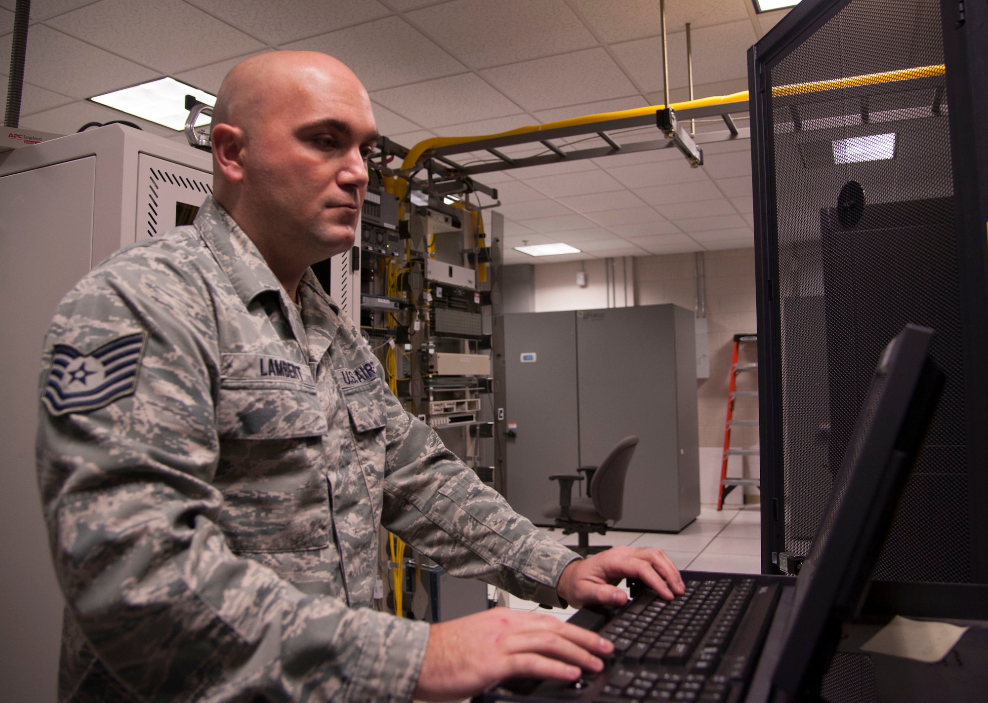Tech. Sgt. Jacob Lambert, a 189th Airlift Wing cyber systems operations craftsman, logs on to his computer to assist Air National Guard units in tracking their patch status Nov. 22, 2013, at Little Rock Air Force Base, Ark. (U.S. Air Force photo by Airman 1st Class Harry Brexel)