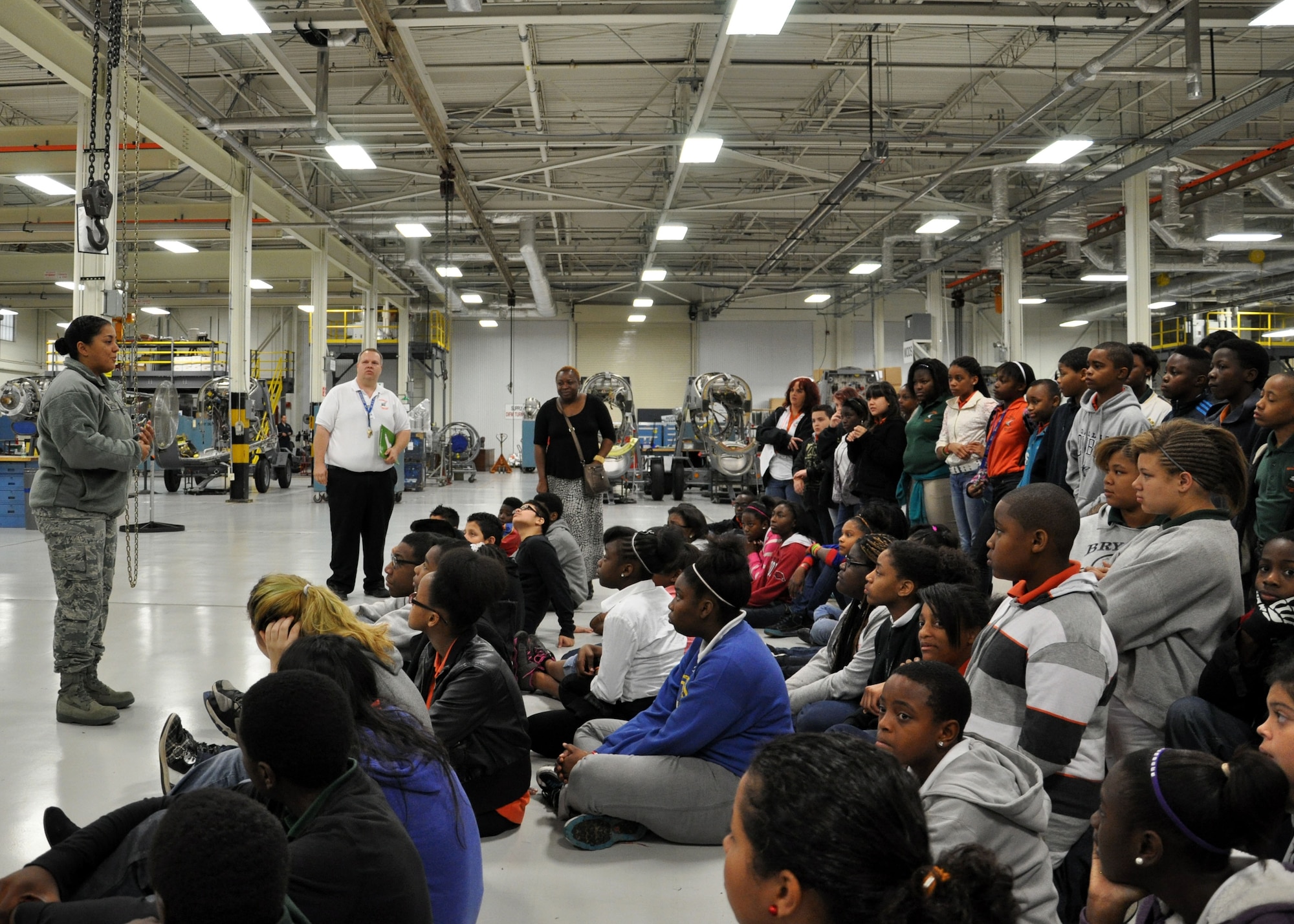 Lt. Col. Maria Moss, 19th Component Maintenance Squadron commander, answers questions from sixth, seventh and eighth graders from the Cloverdale Aerospace Technology Conversion Charter School Nov. 21, 2013, at Little Rock Air Force Base, Ark.  A total of 90 students came to the base to tour the 19th CMS engine shop, the test cell facility and Heritage Park. (U.S. Air Force photo by Senior Airman Regina Agoha)