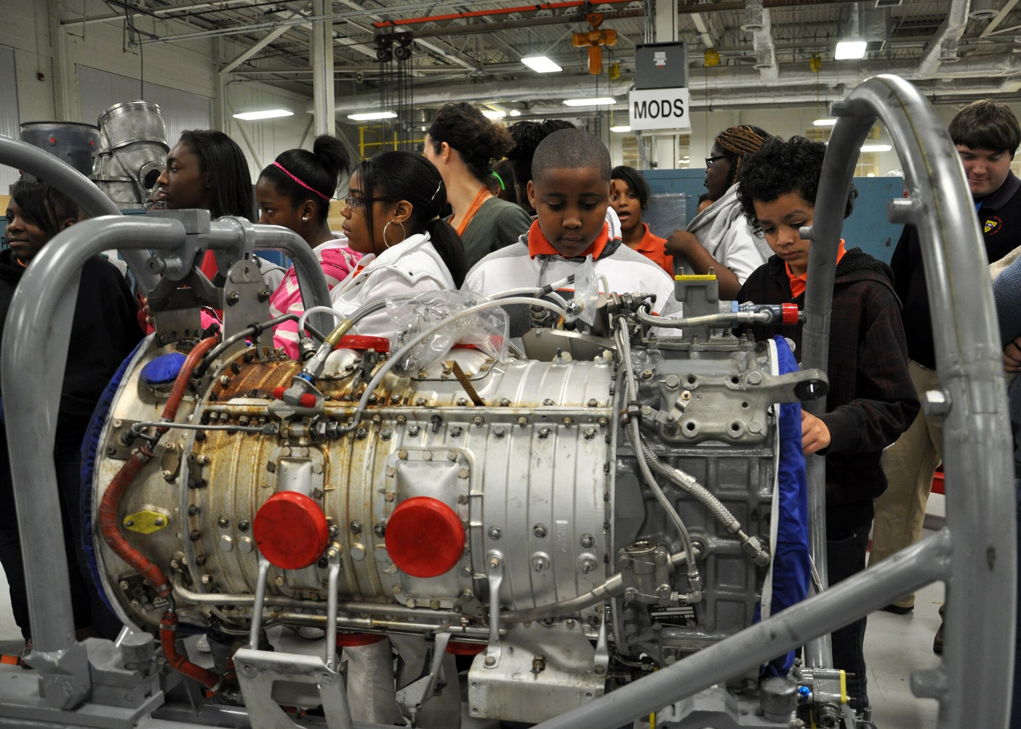 Damonte Shelton, seventh grader from the Cloverdale Aerospace Technology Conversion Charter School, checks out the parts on a compression module during a tour with the 19th Component Maintenance Squadron’s engine shop Nov. 21, 2013, at Little Rock Air Force Base, Ark.  A total of 90 students came to the base to tour the 19th CMS engine shop, the test cell facility and Heritage Park. (U.S. Air Force photo by Senior Airman Regina Agoha)
