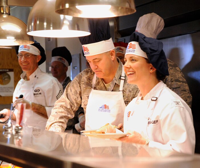 Col. Marné Deranger, 341st Missile Wing vice commander (right), serves food during a Thanksgiving meal along with Col. Mark Schuler, 341st Operations Group commander (center), and Chief Master Sgt. Duane Buchi, 341st Mission Support Group superintendent (left), at the Elkhorn Dining Facility on Nov. 28. More than 200 Airmen were served during the meal. (U.S. Air Force photo/Airman 1st Class Collin Schmidt)