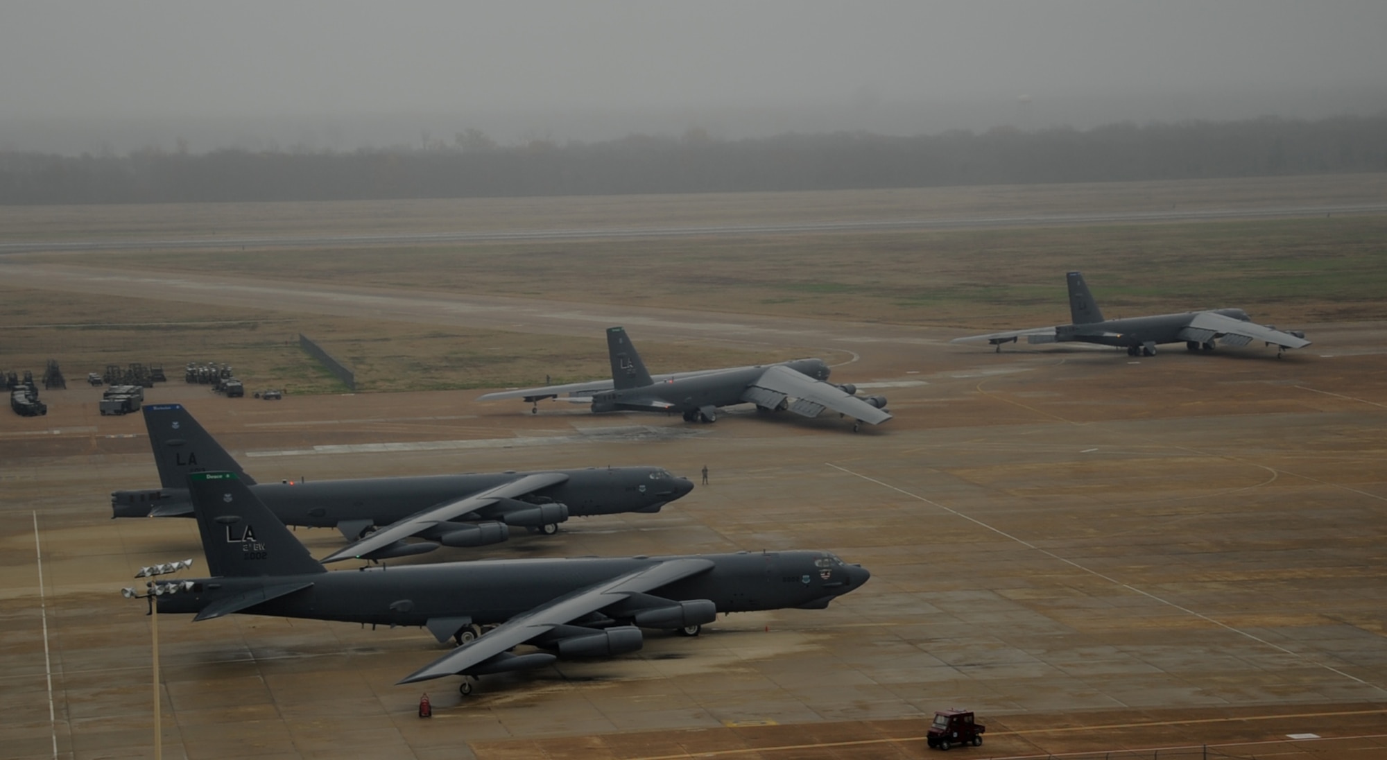 B-52H Stratofortress bombers taxi toward the runway during a during a minimum interval takeoff on Barksdale Air Force Base, La., Dec. 5, 2013. A MITO is a maneuver B-52 crews can use to get their aircraft off the ground as quickly as possible to complete a mission. Each aircraft is equipped with eight starter cartridges, filled with gunpowder, which allow the engines to start up quicker than a normal take-off. This procedure allows B-52s to quickly respond and deliver precision munitions to the battlefield at a moment’s notice (U.S. Air Force photo/Staff Sgt. Sean Martin)