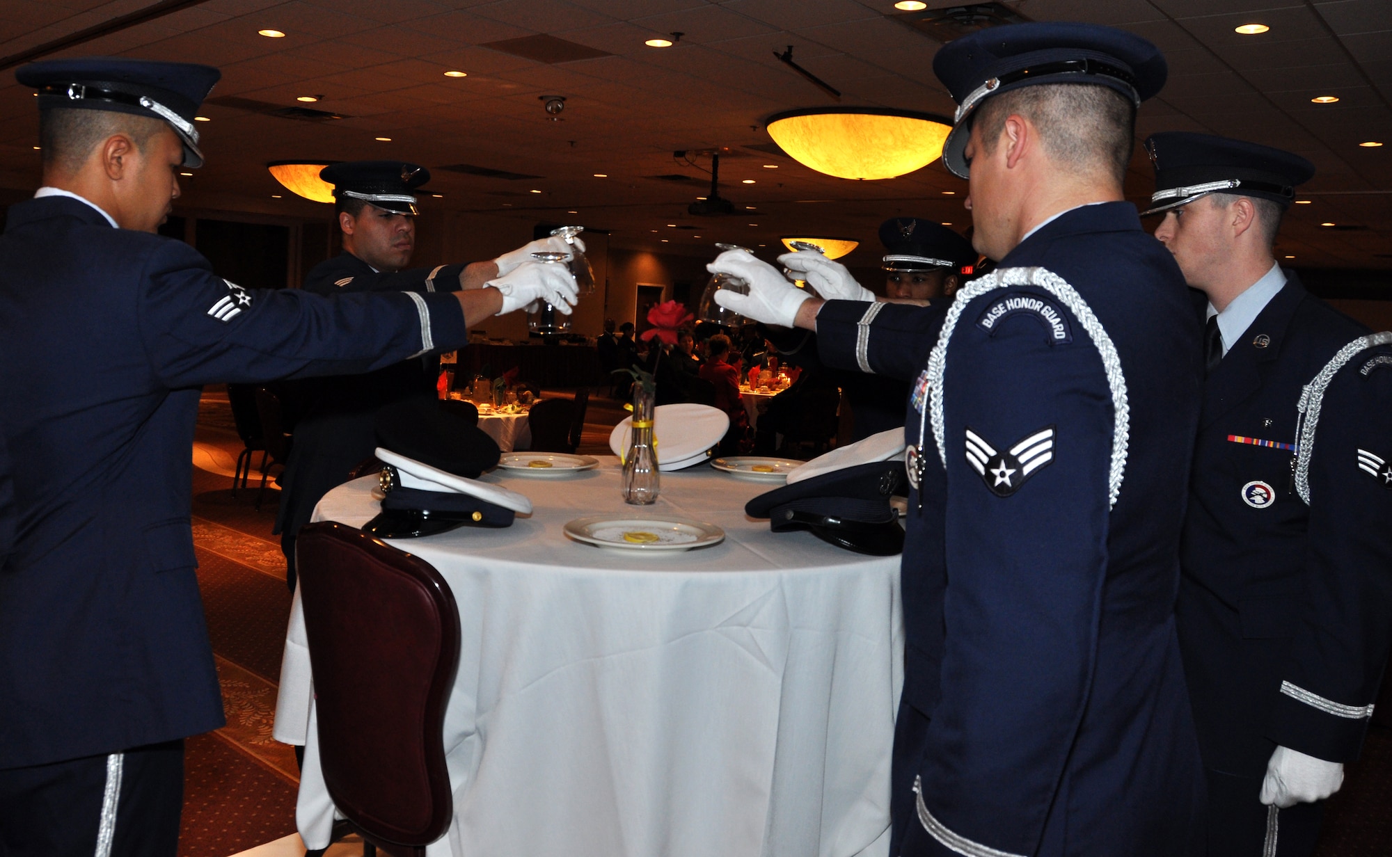 Members from the Tinker Air Force Base Honor Guard turn drinking glasses upside down.  The empty glasses represent our missing military members overseas that cannot share in a toast.  Members and their guests then raise a glass of water to toast their honor.   (U.S. Air Force photo/Maj. Jon Quinlan)