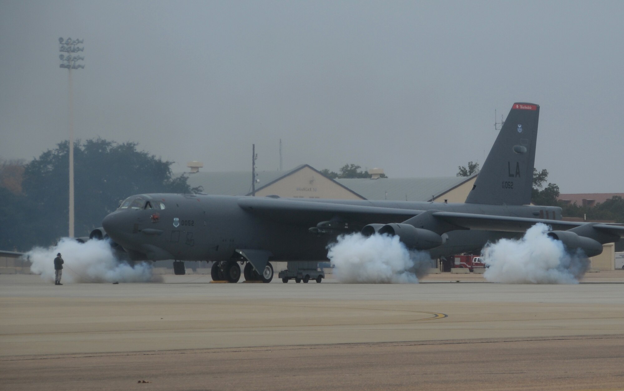 The engines of a B-52H Stratofortress are fired up by starter cartridges filled with gun powder on the flightline at Barksdale Air Force Base, La., Dec. 5, 2013. Ten B-52 crews executed a minimum interval takeoff during a simulated alert. The launch procedure allows our deterrent force to respond as rapidly as possible when called upon. (U.S. Air Force photo/Staff Sgt. Amber Corcoran)