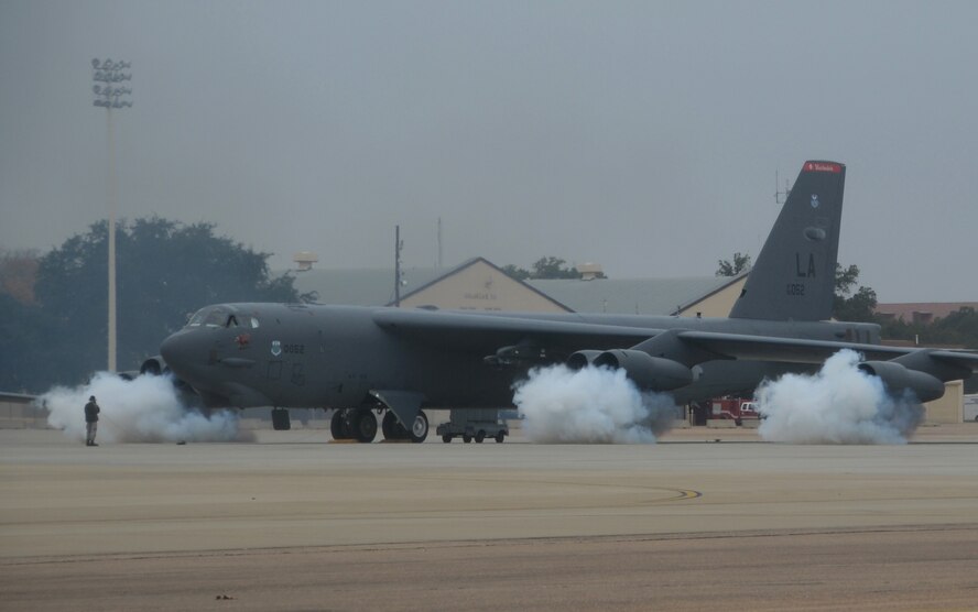 The engines of a B-52H Stratofortress are fired up by starter cartridges filled with gun powder on the flightline at Barksdale Air Force Base, La., Dec. 5, 2013. Ten B-52 crews executed a minimum interval takeoff during a simulated alert. The launch procedure allows our deterrent force to respond as rapidly as possible when called upon. (U.S. Air Force photo/Staff Sgt. Amber Corcoran)
