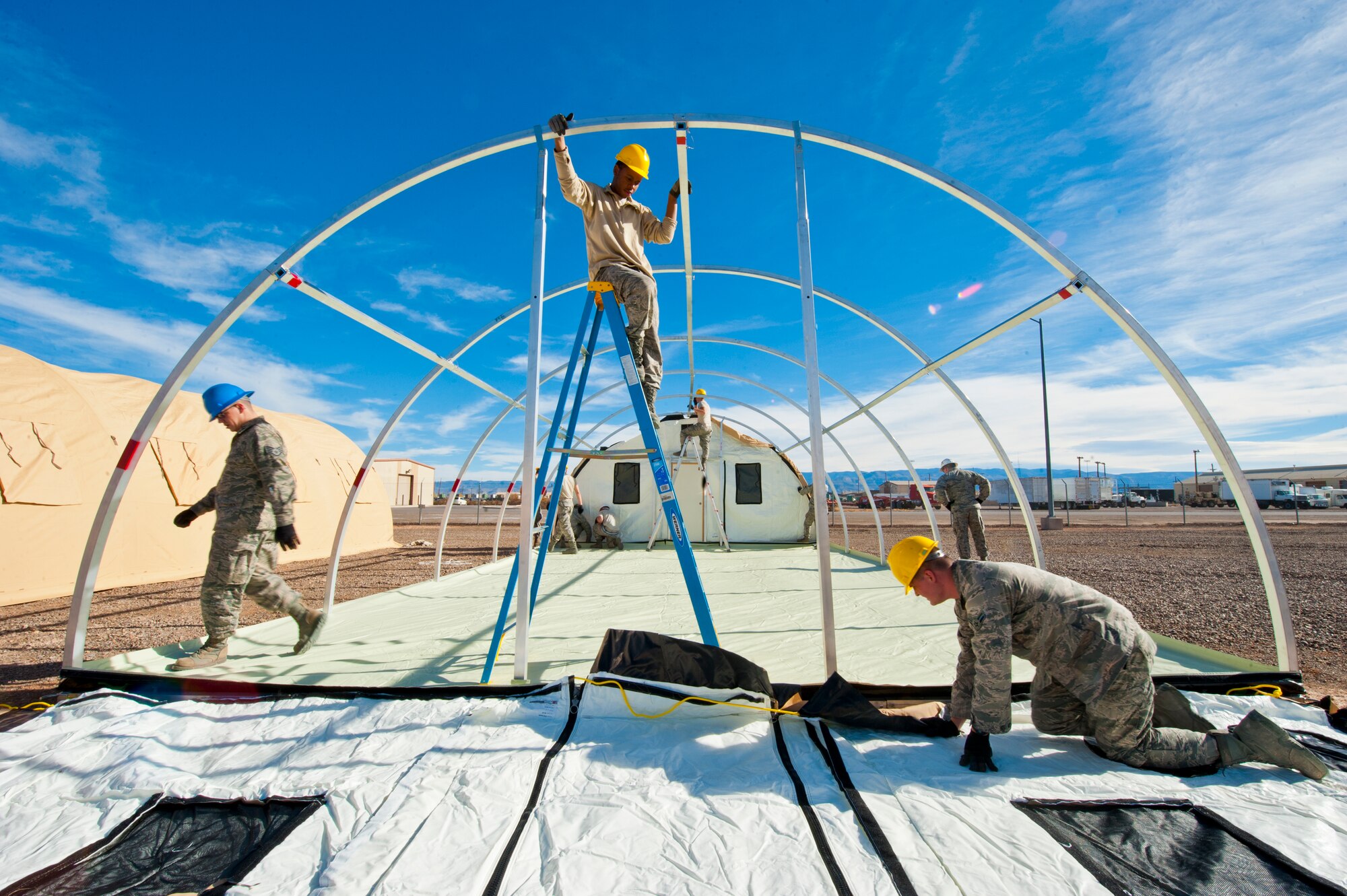 49th Materiel Maintenance Squadron structures Airmen work to construct a Small Shelter System at Holloman Air Force Base, N.M., Dec. 2. The Airmen trained on building fully-ventilated structures such as the SSS to maintain skills needed during construction in deployed environments. The 49th MMS accomplishes the mission by sending large, all-inclusive packaged equipment to deployed locations or to areas impacted by natural disasters. (U.S. Air Force photo by Senior Airman Daniel E.Liddicoet/Released)