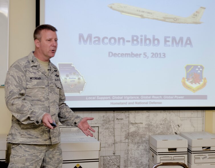 U.S. Air Force Col. Gregory McCreary, 116th Mission Support Group commander, Georgia Air National Guard, speaks with members of the Macon-Bibb County Emergency Management Agency (EMA) while visiting the EMA for the Georgia National Guard podium week, Macon, Ga., Dec. 5, 2013. Podium week was set up to coincide with the 377th birthday of the National Guard. Leaders from Guard units throughout the state took the opportunity to speak to various community groups about the Georgia National Guard mission and successes.  McCreary, along with Public Affairs personnel from the 116th Air Control Wing (ACW), toured the EMA facility followed by a briefing from the Colonel where he shared information about the Guard and the 116th ACW. (U.S. Air National Guard photo by Master Sgt. Roger Parsons/Released)