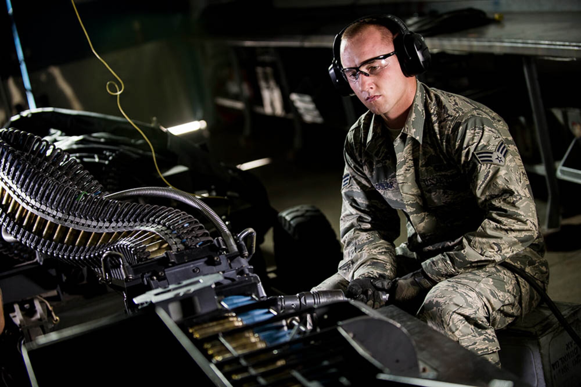 SrA Curtus Cowles processes 20mm ammo using the Universal Ammunition Loading System. The 20mm rounds are used on the F-16's internal gun system. (U.S. Air National Guard photo by John Alderman/Released)
