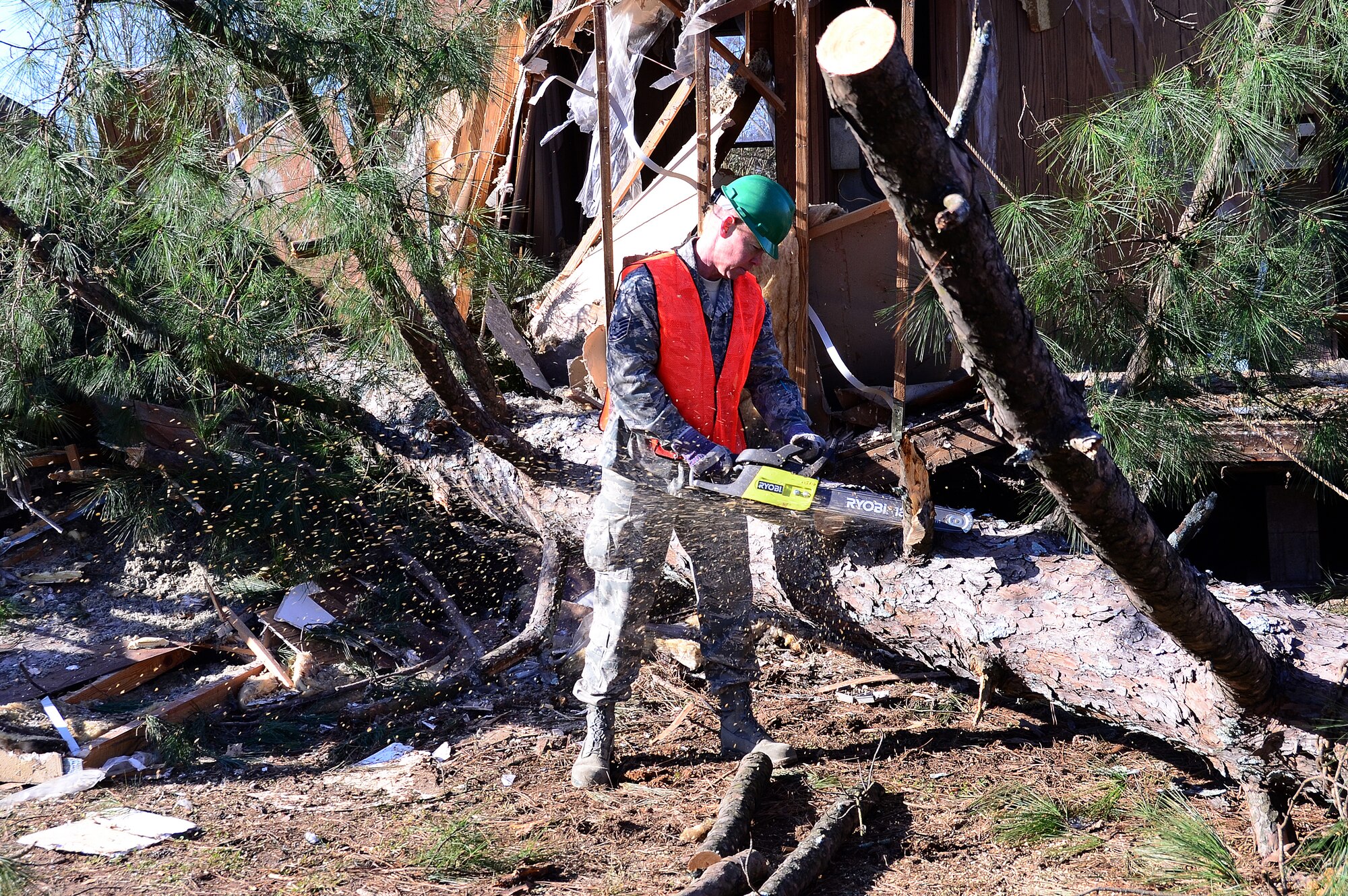 Tech. Sgt. Preston Caldwell of the 94th Operations Support Squadron assists residents of recently tornado-stricken Adairsville, Ga. with post storm clean-up Jan. 30. Caldwell and other volunteers cut down and cleared more than twelve damaged trees. (photos by Senior Airman Elizabeth Van Patten)