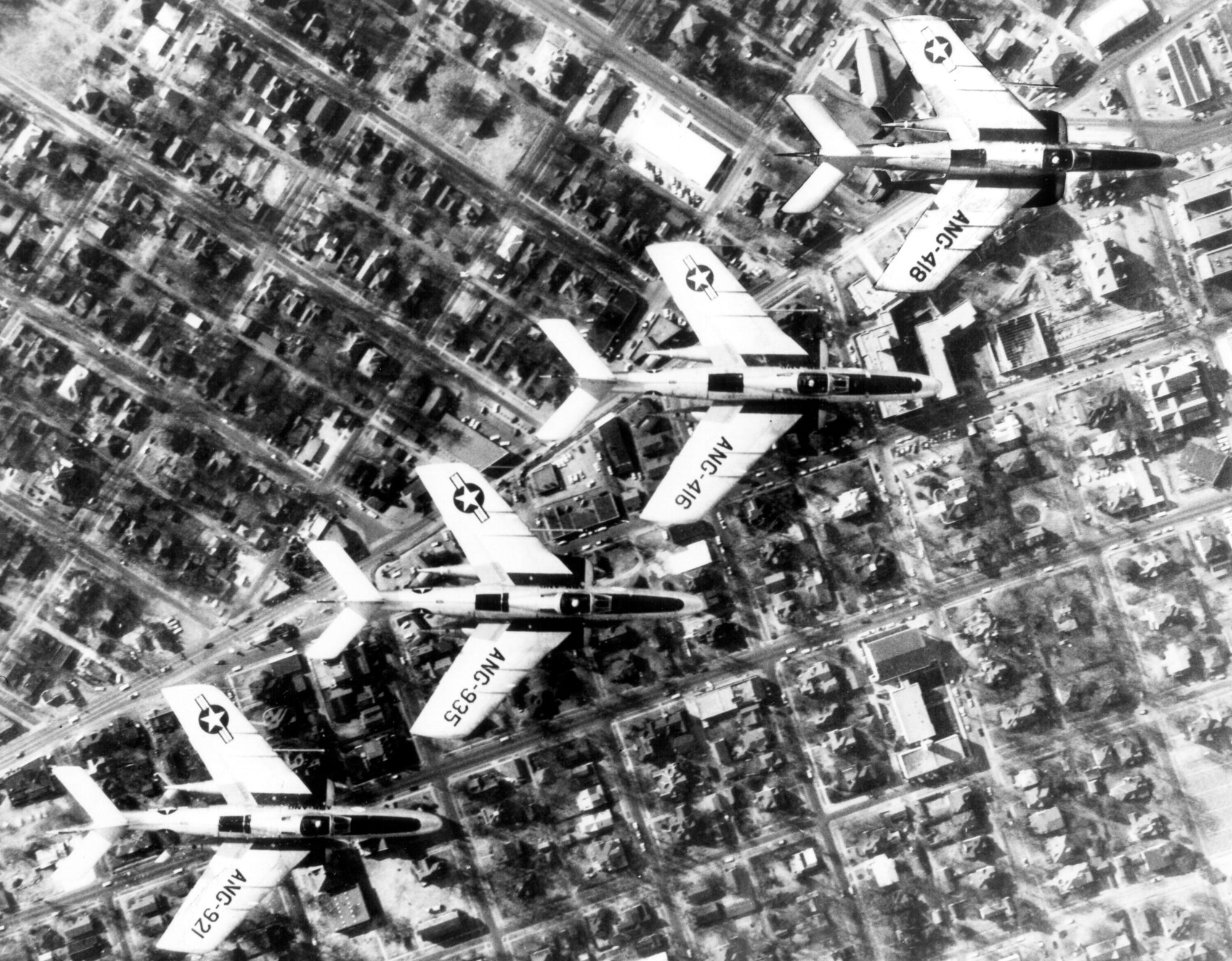 A four-ship of RF-84 "Thunderflash" aircraft from the 184th Tactical Reconnaissance Squadron as the 188th Fighter Wing was dubbed in 1959, flies over Rogers Avenue in downtown Fort Smith, Ark. The RF-84 was the unit's third mission aircraft. The 184th flew RF-84s from August 1957 through December 1971. This photo graced the front of the unit's official 1959 Christmas card, so it seems somewhat fitting that this image was selected for the December 2013 Flying Razorback Flashback. A careful study of the streets and buildings will show some of the innumerable changes Fort Smith has experienced in the 54 years since this photo was captured. What hasn't changed is that the men and women of the Arkansas Air National Guard are still a fixture in Fort Smith. (Courtesy photo)