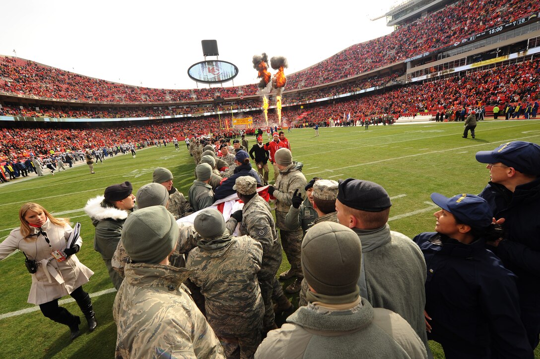 Service members fold the American flag following the conclusion of a military appreciation pre-game ceremony at Arrowhead Stadium in Kansas City, Mo., Nov. 24, 2013. As a symbol of appreciation to those who serve, each year the Kansas City Chiefs give out a select number of tickets to volunteers who present the flag. (U.S. Air Force photo by Staff Sgt. Nick Wilson/Released)