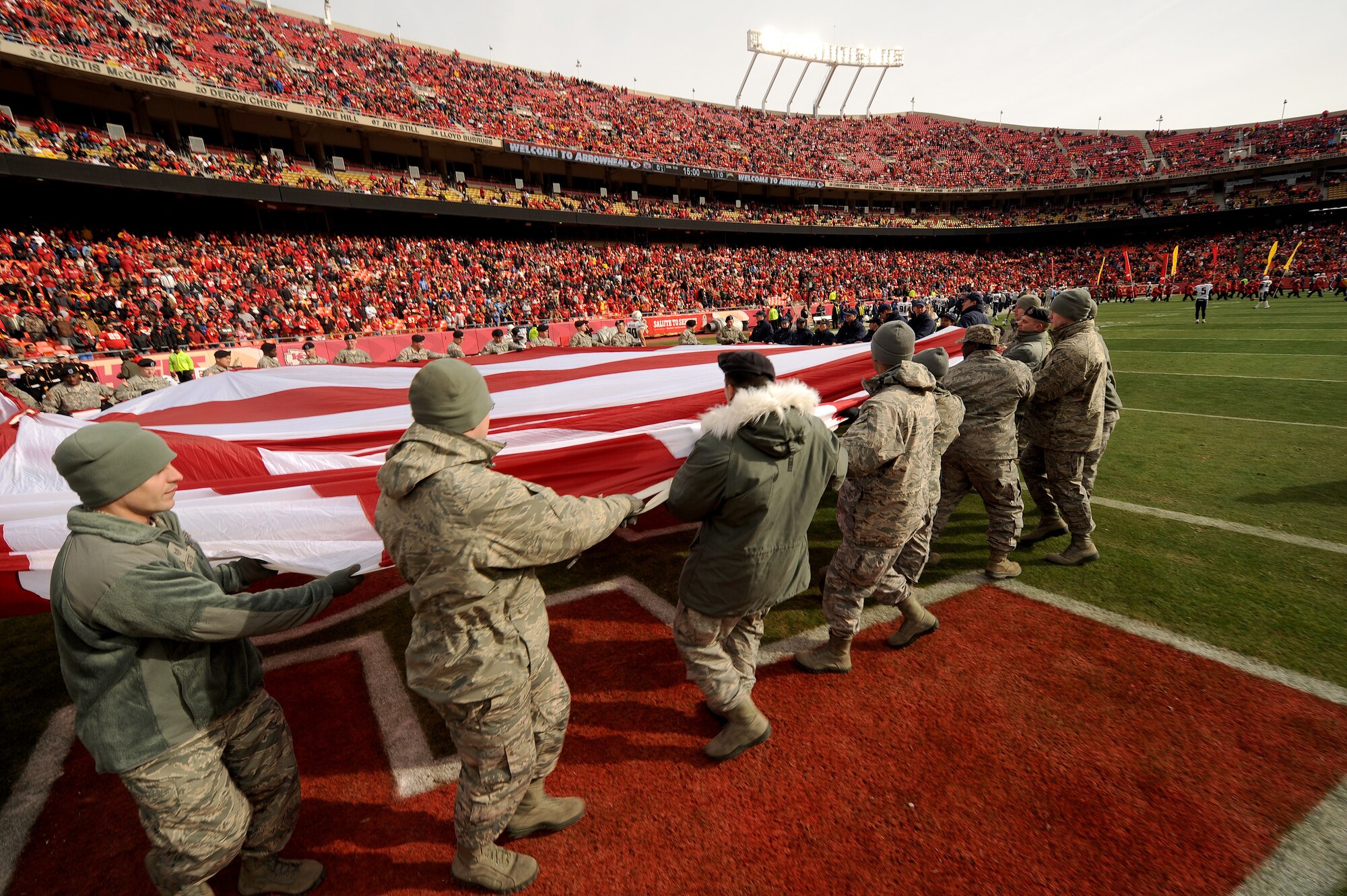 Airmen present the American flag during the pre-game ceremony of a military appreciation game at Arrowhead Stadium in Kansas City, Mo., Nov. 24, 2013. In addition to the pre-game ceremony, various Service members who served overseas were given souvenirs during presentations throughout the game. (U.S. Air Force photo by Staff Sgt. Nick Wilson/Released)