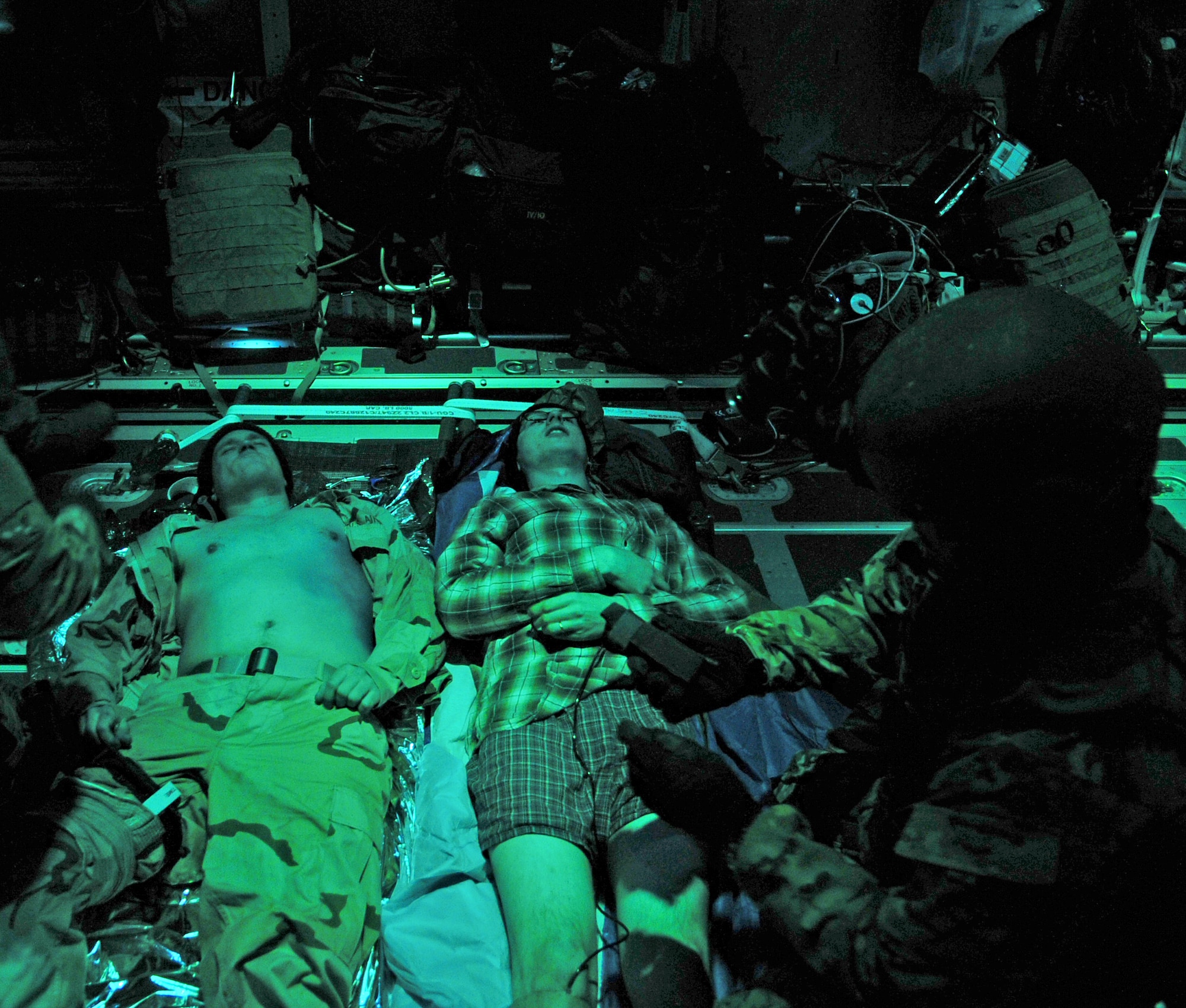 U.S. Air Force Airmen from the 352nd Special Operations Support Squadron Medical Operations Flight examine simulated patients’ injuries Nov. 20, 2013, during a casualty evacuation exercise. The 67th Special Operations Squadron and 352nd SOSS participated in the CASEVAC training, which tested Airmen on their ability to care for and transport wounded service members under tactical conditions similar to what would be encountered in a combat environment. (U.S. Air Force photo by Senior Airman Christine Griffiths/Released)