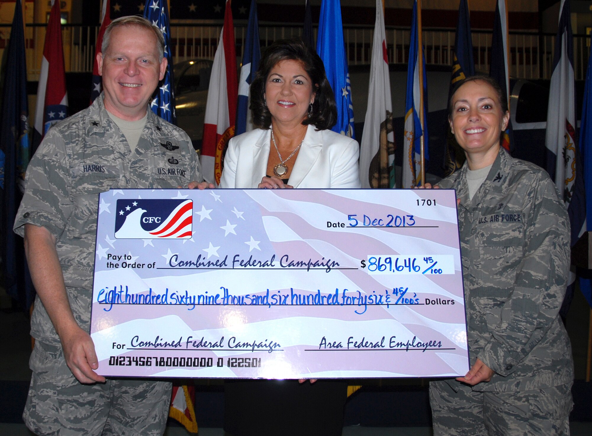 Brig. Gen. David Harris, the 96th Test Wing commander and Col. Angela Montellano, the 1st Special Operations Dental Squadron commander at Hurlburt Field, present a check for $869,646.45 to Martha Miller, the United Way chairman-elect of the board for Okaloosa and Walton counties, at the Combined Federal Campaign victory celebration at the Air Force Air Armament Museum Dec. 5. The check represented funds gathered at Eglin Air Force Base, Hurlburt Field and area federal agencies during this year’s CFC drive. (U.S. Air Force photo/Kevin Gaddie)