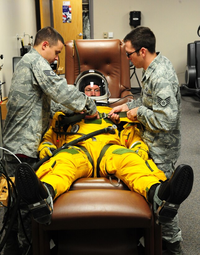 Maj. Gen. James N. Post III, Air Combat Command director of operations, rests in a full pressure suit while Airmen from the 9th Physiological Support Squadron conduct maintenance checks upon the suit Dec. 3, 2013, at Beale Air Force Base Calif. Full pressure suits are designed to protect aviators aboard U-2 Dragon Lady’s. The U-2 is the highest flying operational aircraft in the Air Force, often exceeding altitudes’ more than 70,000 ft. (U.S. Air Force photo by Airman 1st Class Bobby Cummings/Released)