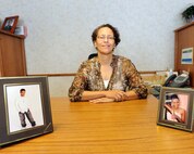 Sonia L. Brumskill, 319th Mission Support Group commander's secretary, poses with pictures of her children Dec. 4, 2013, on Grand Forks Air Force Base, N.D. The Keyport, N.J., native is the 319th Air Base Wing’s Warrior of the Week for the first week of December 2013. (U.S. Air Force photo/Airman 1st Class Zachiah Roberson)