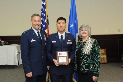 Col. Gerald Goodfellow (left), 12th Flying Training Wing commander, Joint Base San Antonio-Randolph, and Susan Green Tillman (center right), State Recording Secretary of Texas, Daughters of the American Revolution, present Capt. Jay H. Park with the Instructor Navigator/Combat Systems Officer of the Year Award. (U.S. Air Force photo by Rich McFadden)