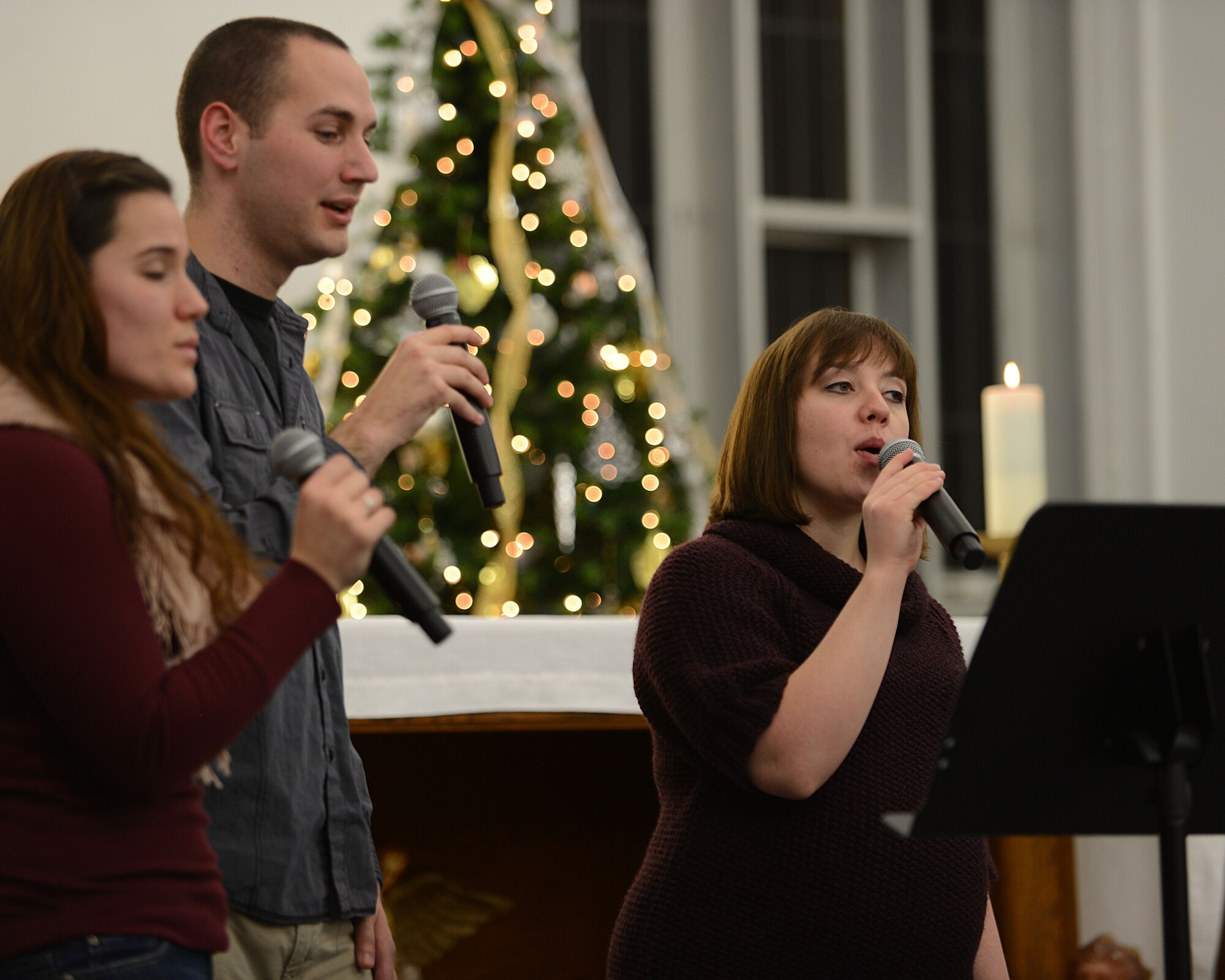 Members of the RAF Mildenhall Praise Team sing contemporary Christmas songs at the Christmas Music Extravaganza Dec. 4, 2013, in the chapel on RAF Mildenhall, England. The extravaganza hosted performers from RAF Mildenhall, RAF Lakenheath and the local community. The event offered a chance for service members and their families to socialize and get in reward. (U.S. Air Force photo by Airman 1st Class Preston Webb/Released)