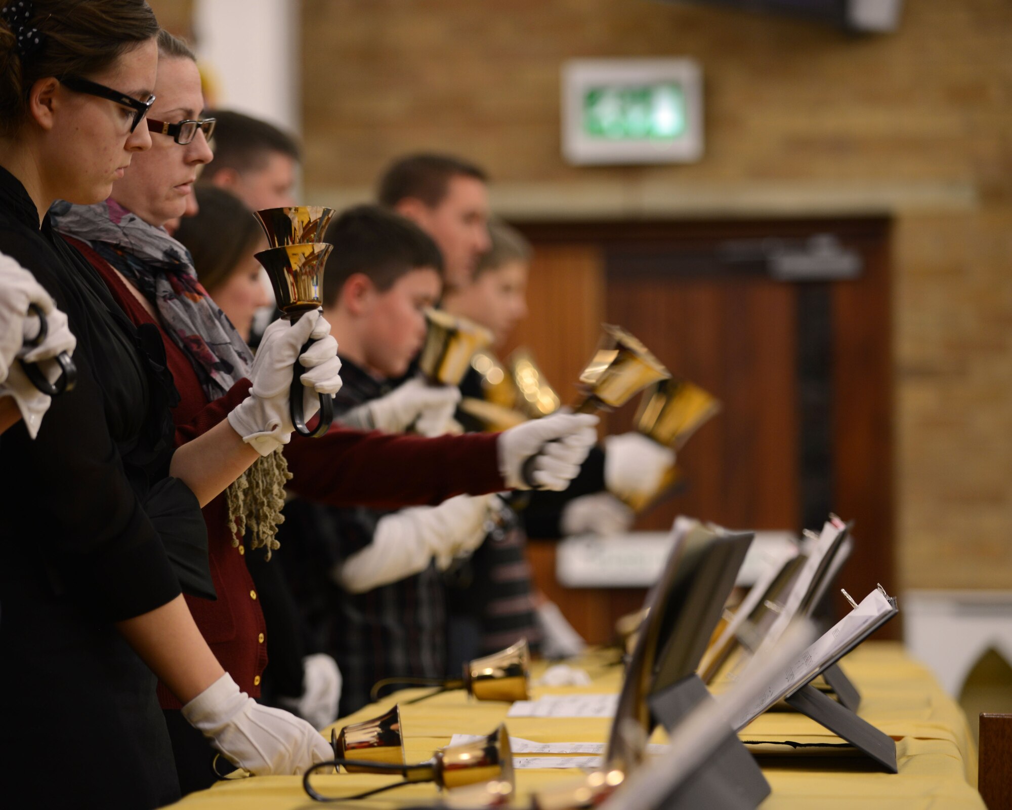 The RAF Lakenheath Hand Bell Choir performs at the Christmas Music Extravaganza Dec. 4, 2013, in the chapel on RAF Mildenhall, England. Performers from RAF Mildenhall, RAF Lakenheath and the local community joined together for the service. The event offered a chance for service members and their families to socialize and get reward. (U.S. Air Force photo by Airman 1st Class Preston Webb/Released)