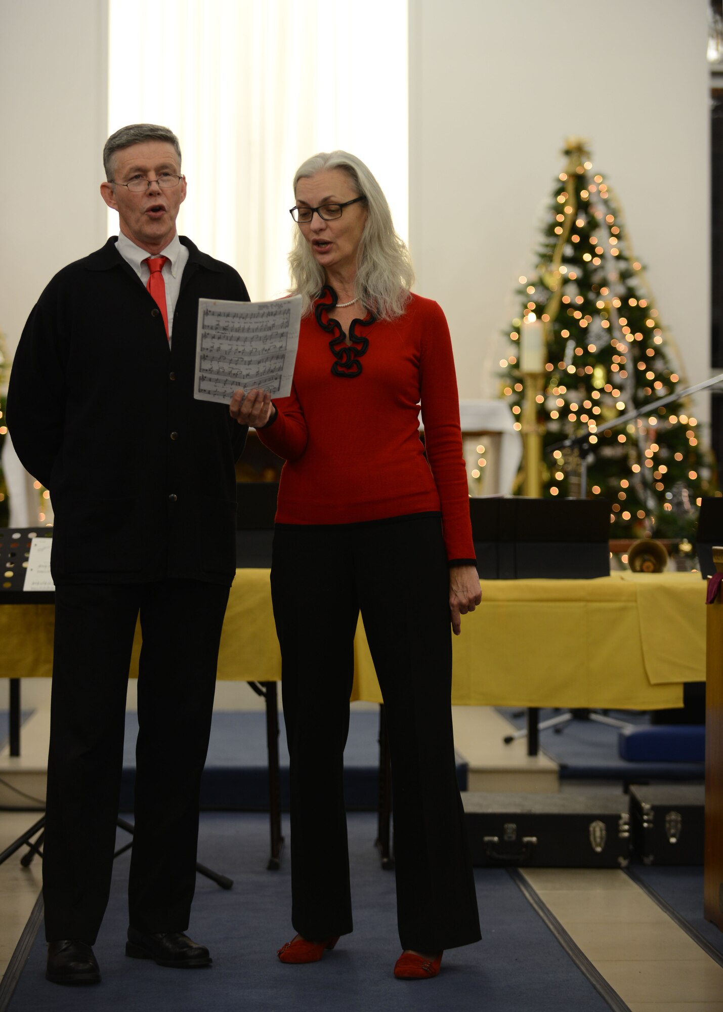 The RAF Mildenhall Byzantine Choir, comprised of U.S. Air Force Lt. Col. Henry Close, chaplain, 100th Air Refueling Wing, and his wife, Annette, sings hymns during Christmas Music Extravaganza Dec. 4, 2013, in the chapel on RAF Mildenhall, England. The extravaganza hosted performers from RAF Mildenhall, RAF Lakenheath and the local community. The joint service was the first of its kind for RAF Mildenhall. (U.S. Air Force photo by Airman 1st Class Preston Webb/Released)
