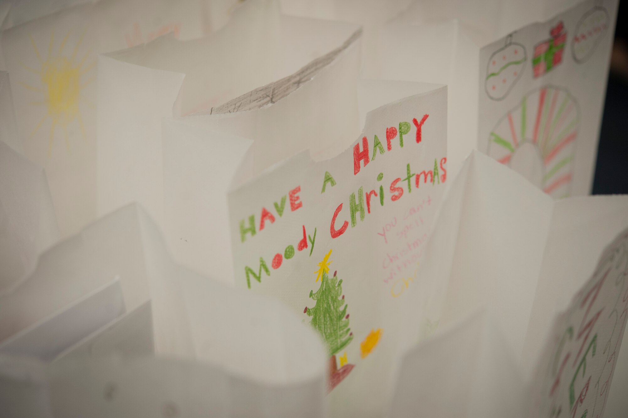 Decorated bags sit on a table waiting to get filled with homemade cookies and holiday cards for Airmen living at the dorms at Moody Air Force Base, Ga., Dec. 4, 2013. Local elementary and middle school students decorated the bags. (U.S. Air Force Photo by Airman 1st Class Sandra Marrero/Released)
