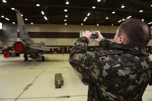 SPANGDAHLEM AIR BASE, Germany – A Ukrainian inspector takes a picture of a U.S. Air Force F-16 Fighting Falcon fighter aircraft Dec. 5, 2013. The Conventional Armed Forces in Europe treaty allows NATO countries and former states and satellites of the Soviet Union to inspect military installations to determine the number of personnel and war-fighting equipment. (U.S. Air Force photo by Airman 1st Class Kyle Gese/Released)