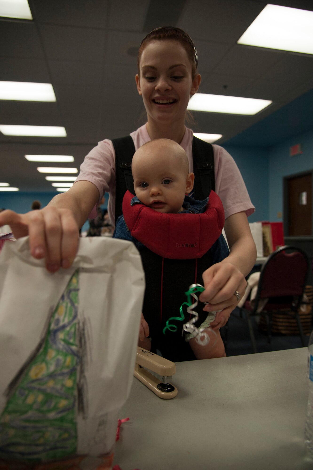 Jessica Overcast, wife of U.S. Air Force Senior Airman Matthew Overcast, puts a ribbon on a cookie package to be sent to an Airman at Moody Air Force Base, Ga., Dec. 4, 2013. The Airman Cookie Drive strives to donate at least 1,000 cookies to Airmen each year. (U.S. Air Force Photo by Airman 1st Class Sandra Marrero/Released)
