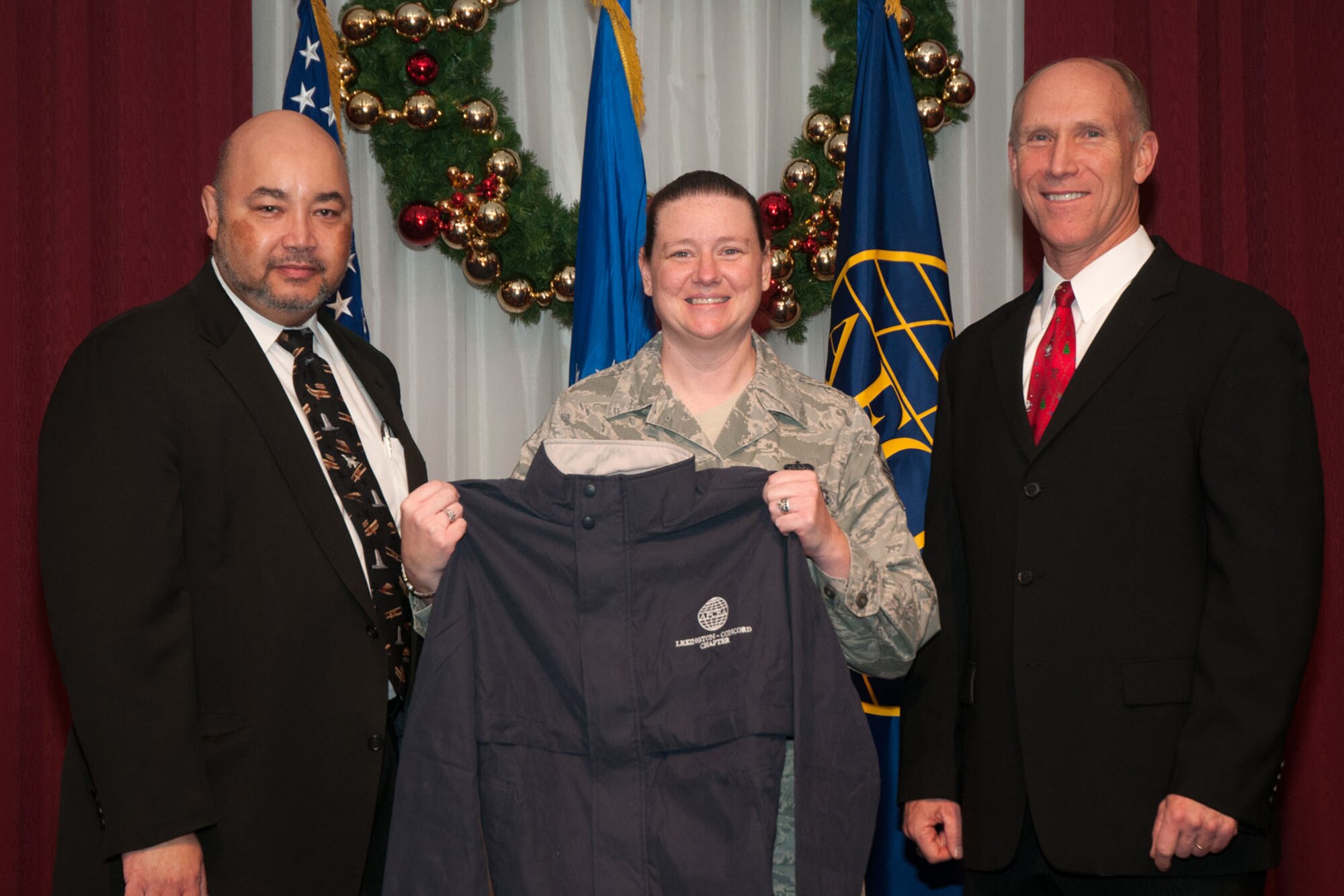 HANSCOM AIR FORCE BASE, Mass. -- Albert J. Griggs Jr., Battle Management Directorate deputy director (left) and Donald Vazquez, Armed Forces Communications and Electronics Association Lexington-Concord chapter president, presents Master Sgt. Christy Podunajec with the AFCEA Unsung Hero Award at the Minuteman Commons Dec. 4. Program Executive Offices, the 66th Air Base Group and the Mass. National Guard each selected a hero who made outstanding contributions to their respective organization in 2013. Other recipients were Mel Tillman, AFLCMC/AQ-OL; Dawn Andreucci, 66 ABG; Steve O'Neil, C3I and Networks Directorate; U.S. Army Staff Sgt. Eben J. Darling, Mass. National Guard; Kimberly Matthews, AFCEA. (U.S. Air Force photo by Mark Herlihy)
