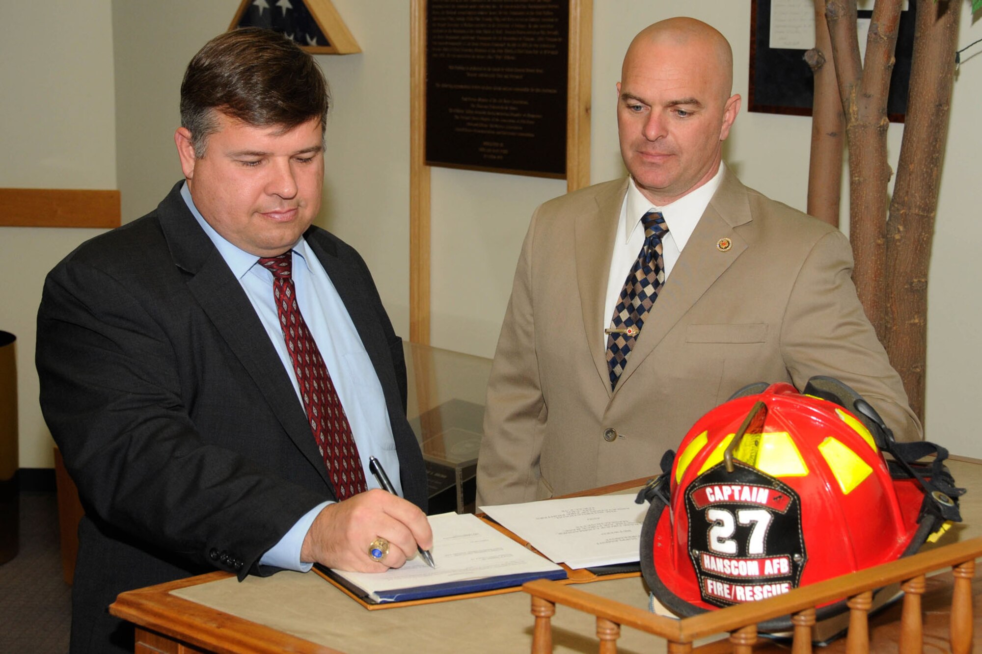 HANSCOM AIR FORCE BASE, Mass. -- Tom Fredericks, 66th Air Base Group deputy Director, and Dale Smith, IAFF Local F-78 president, sign a re-negotiated Local Supplement Agreement during a meeting with union and Labor Relations representatives in Building 1305 Nov. 25. (U.S. Air Force photo by Linda LaBonte Britt)