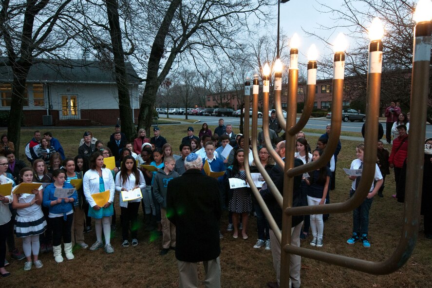HANSCOM AIR FORCE BASE, Mass. – Members of the community attend the annual Menorah Lighting Ceremony outside the Base Chapel Dec. 2. The Menorah Lighting commemorates the eight-day celebration of Hanukkah, Nov. 27 through Dec. 5, also known as the Festival of Lights. During each night of the festival, an additional candle is lit. (U.S. Air Force photo by Mark Herlihy)