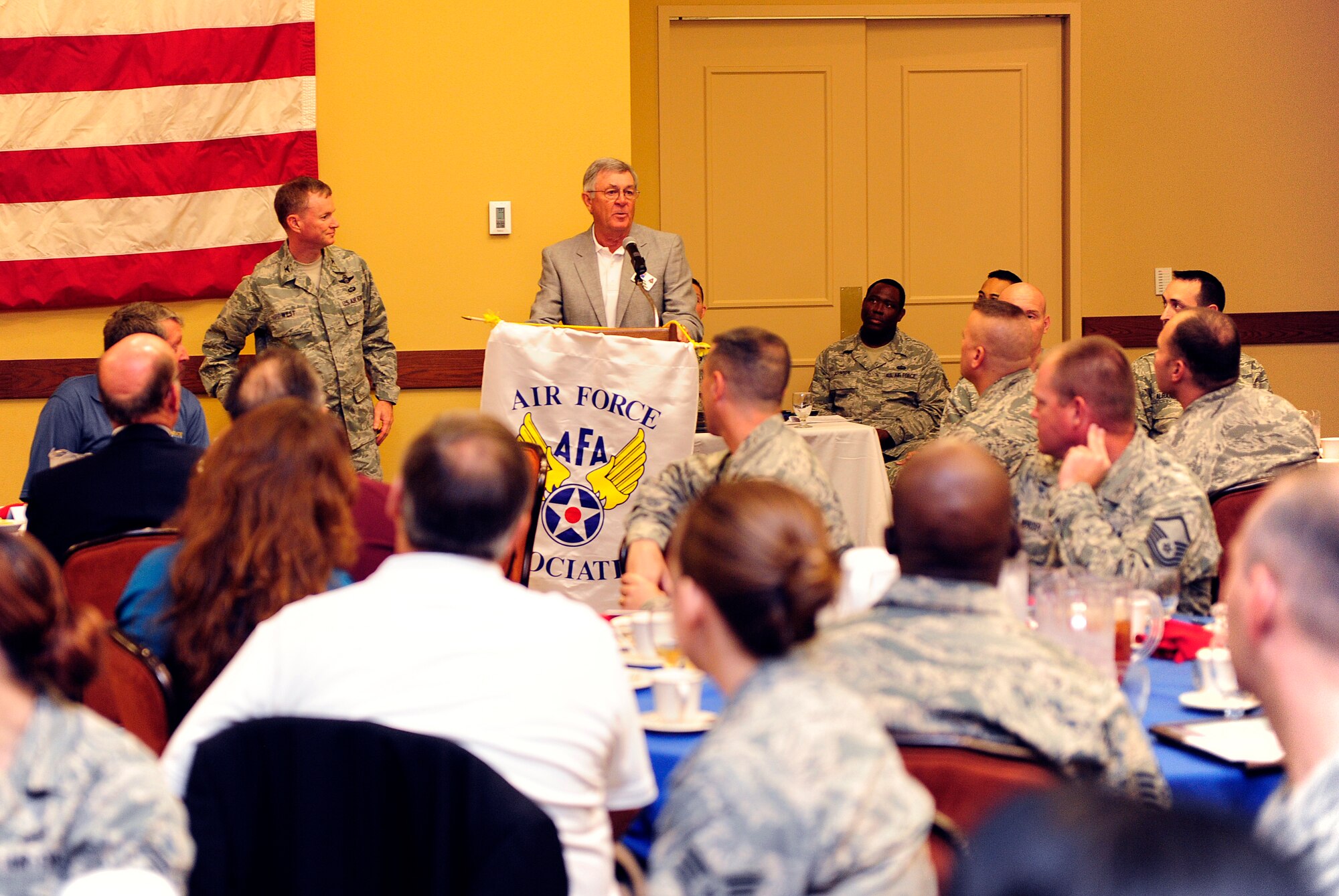 Max Friedauer, previous Air Force Association president, introduces Col. William West, 1st Special Operations Wing commander, during an unsung hero award ceremony at the Soundside Club on Hurlburt Field, Fla., Dec. 4, 2013. The award highlights outstanding performers who have not been previously recognized. (U.S. Air Force photo/Staff Sgt. Jeff Andrejcik)
