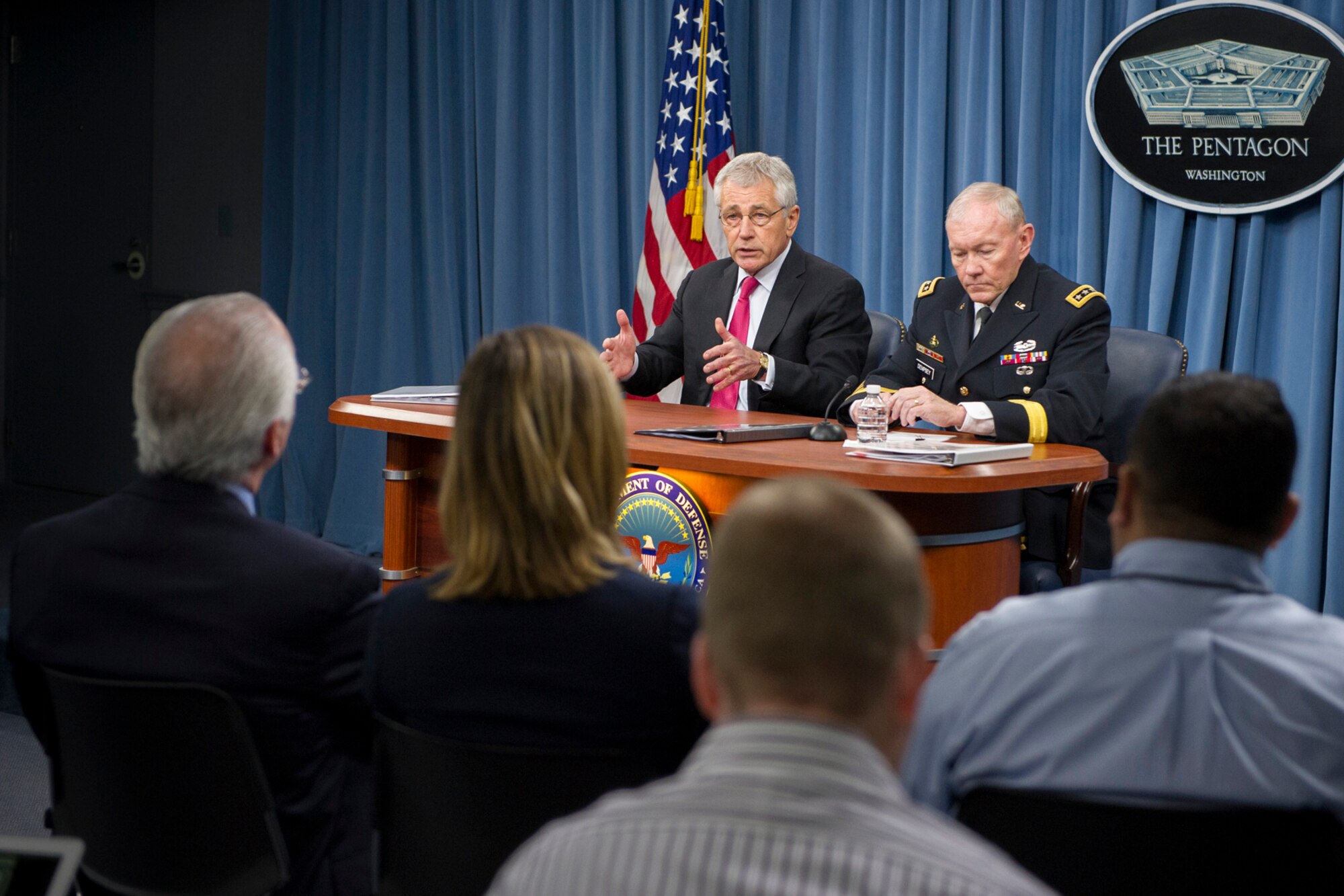 Defense Secretary Chuck Hagel and Army Gen. Martin E. Dempsey, chairman of the Joint Chiefs of Staff, brief reporters in a press conference at the Pentagon, Dec. 4, 2013. Leaders discussed topics including the defense budget and organizational review. (DOD photo by U.S. Navy Petty Officer 1st Class Daniel Hinton)  
