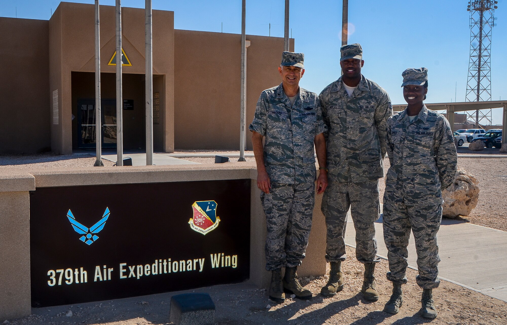 Haltom High School alumni, Gen. Roger H. Watkins (1981) and siblings Staff Sgt. Everett Myles (2004) and Senior Airman Bahja Jones (2008) pose for a group photo at the 379th Air Expeditionary Wing in Southwest Asia, Dec. 4, 2013. The three Fort Worth, Texas natives, joined the Air Force in 1986, 2004 and 2010, respectively. Watkins is the 379th AEW commander on a two-year rotation. Myles is a 379th Expeditionary Maintenance Squadron conventional maintenance crew chief deployed from Dyess Air Force Base, Texas, and Jones is a 379th AEW public affairs photojournalist deployed from Joint Base Andrews, Md. (U.S. Air Force photo/Senior Airman Jared Trimarchi) 