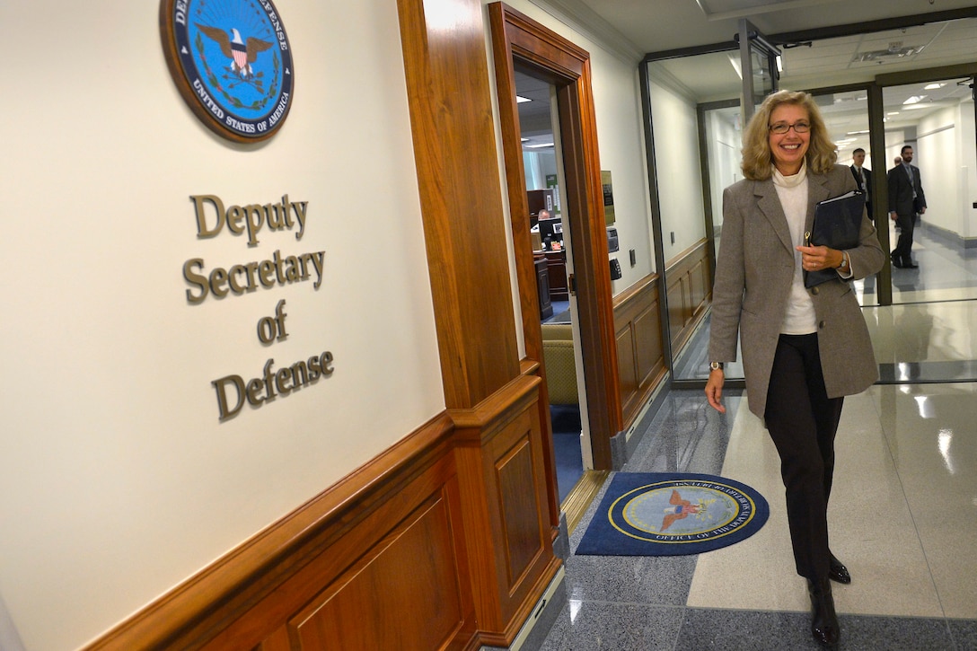 Acting Deputy Defense Secretary Christine H. Fox departs her office to chair a meeting of senior Pentagon officials as she begins her first day in her new position at the Pentagon, Dec. 5, 2013. 