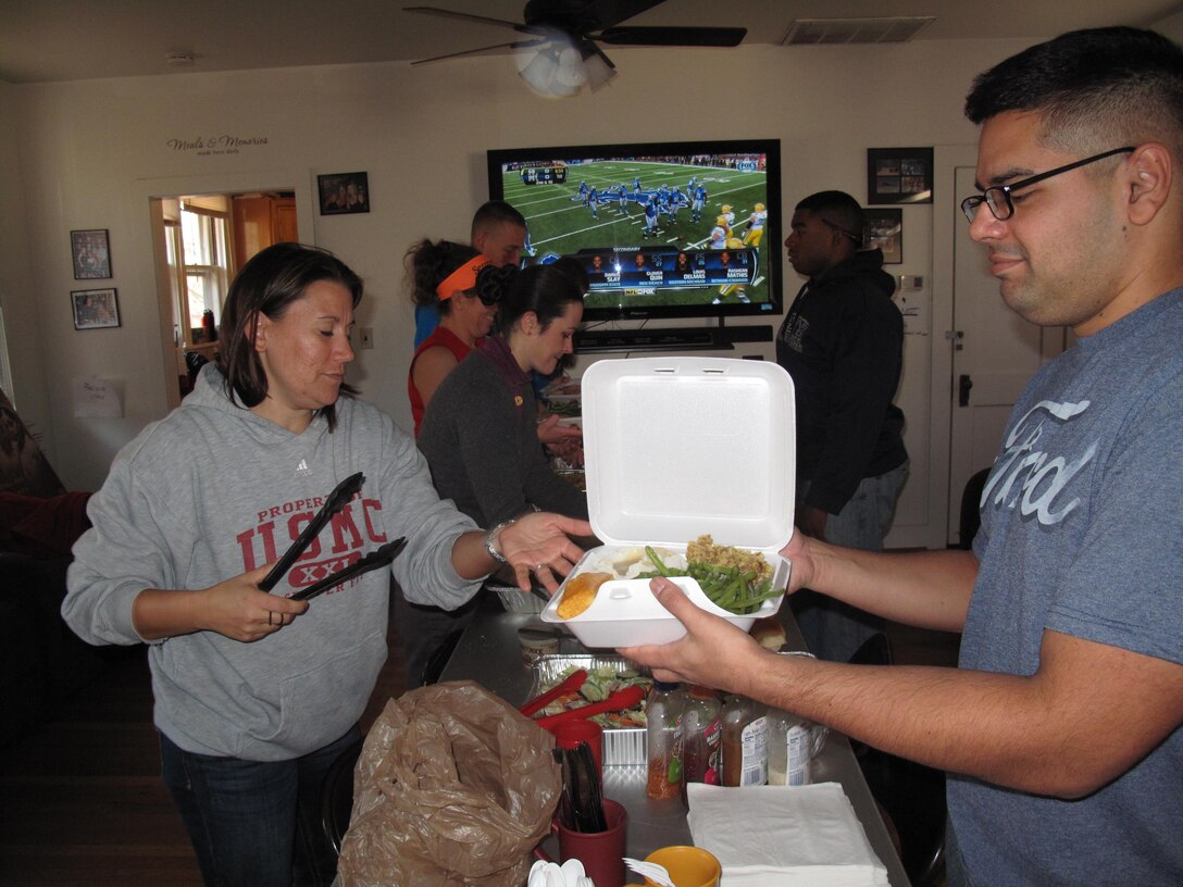 Marines fill thier plates full of Thanksgiving dinner at the Single Marine Program house, Thanksgiving Day on Nov. 28, 2013. The SMP house was created to give the Marines on base a place to spend thier days.