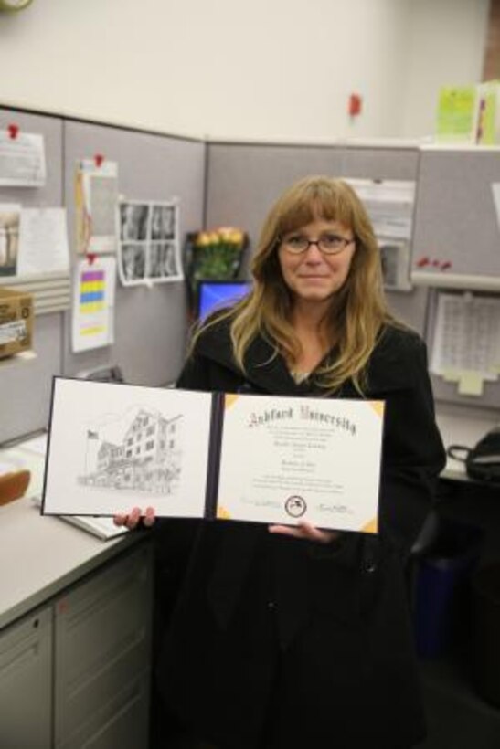 Jennifer Courtney, accounting technician on Marine Corps Logistics Base Barstow, Calif., holds her bachelor’s degree she earned through Ashford University using Department of Defense employee tuition reimbursement, Nov. 26. Courtney furthered her education to advance in her career field.


