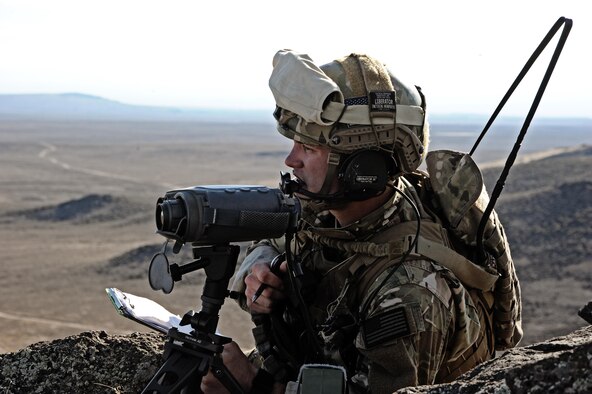 Airman 1st Class Neil Mooney watches simulated enemy targets at an observation point Nov. 1, 2013, at the Orchard Training Combat Center near Boise, Idaho. During the training with AH-64 Apache Helicopters from Joint Base Lewis-McChord, Wash., Mooney called strikes to the simulated enemy targets. Mooney is a tactical air control party specialist from the 124th Air Support Operations Squadron. (U.S. Air National Guard photo/Master Sgt. Becky Vanshur)