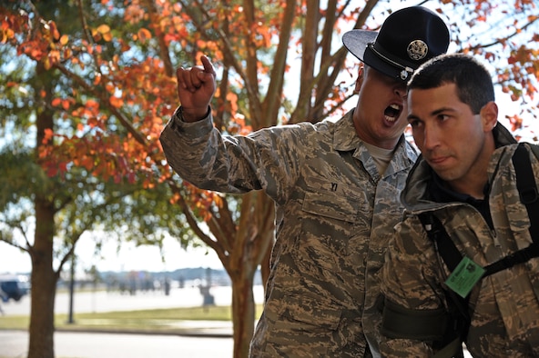 Tech. Sgt. Chi Yi welcomes new an officer trainee to Officer Training School Nov. 13, 2013, at Maxwell Air Force Base, Ala. Yi and his fellow military training instructors will instill basic military knowledge during the OTs time here. (U.S. Air Force photo/Airman 1st Class William Blankenship) 