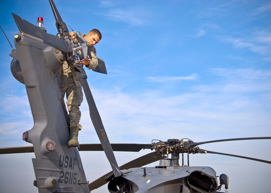 Tech. Sgt. Christopher Dominguez conducts a HH-60G Pavehawk helicopter tail rotor inspection Nov. 26, 2013, at Moffett Federal Air Field, Calif.  Maintainers can be tasked to maintain multiple aircrafts and engines types. Dominguez is assigned to the 129th Rescue Wing Maintenance Squadron. (U.S. Air Force photo/Senior Airman John D. Pharr III)